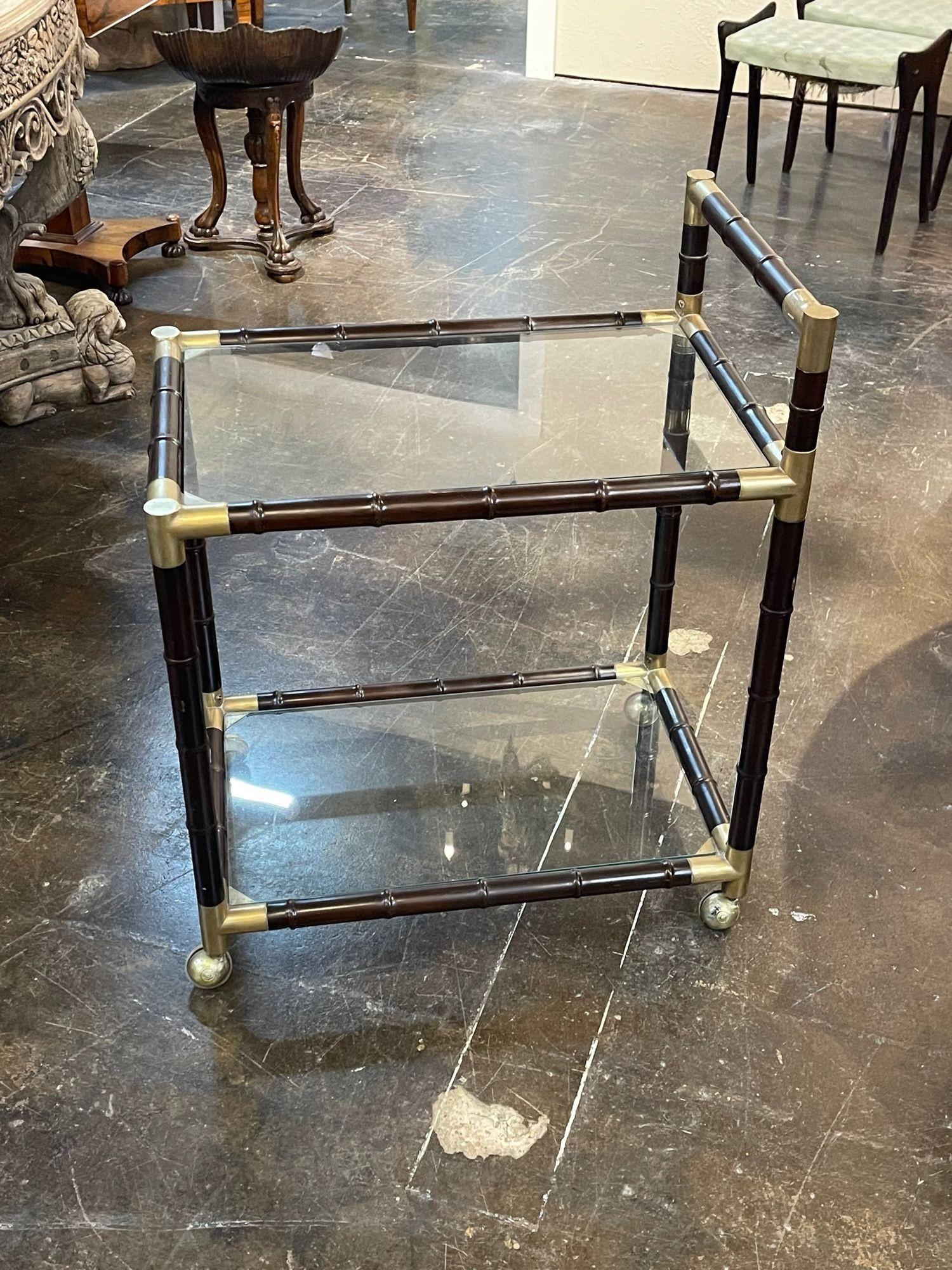 Very nice Italian Mid-Century Modern brass and bamboo form bar car. The piece has 2 glass shelves and is on casters. Decorative as well as useful!