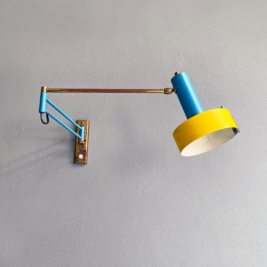 Italian mid century modern brass and colored metal adjustable arm lamp, 1950s
Adjustable arm lamp with adjustable brass rod structure, with joint also present on the yellow and blue metal diffuser to allow positioning.
1950s.
Good