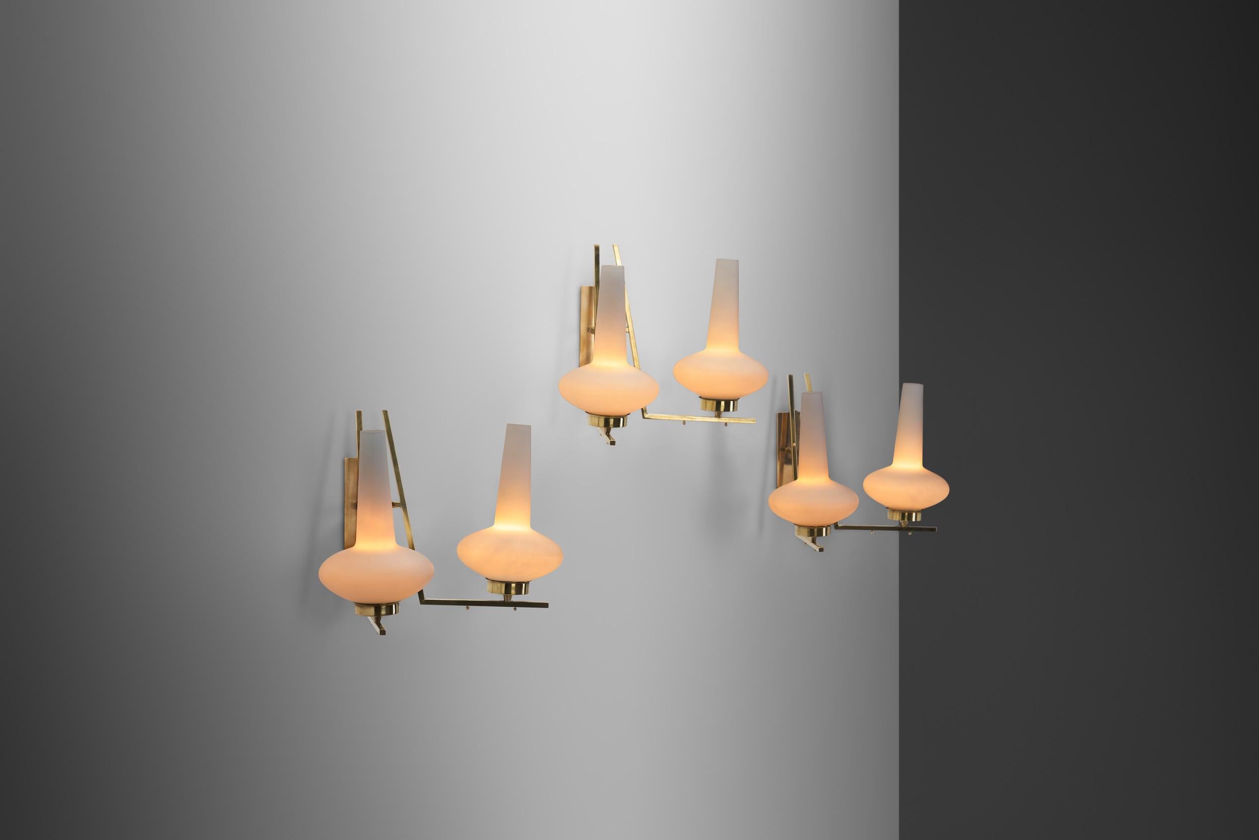 Italian Mid-20th century lighting design was infinitely captivating, featuring one-of-a-kind models crafted by renowned Italian designers such as Ettore Sottsass, Gio Ponti, Gavina and other internationally esteemed names. As these wall lamps show,