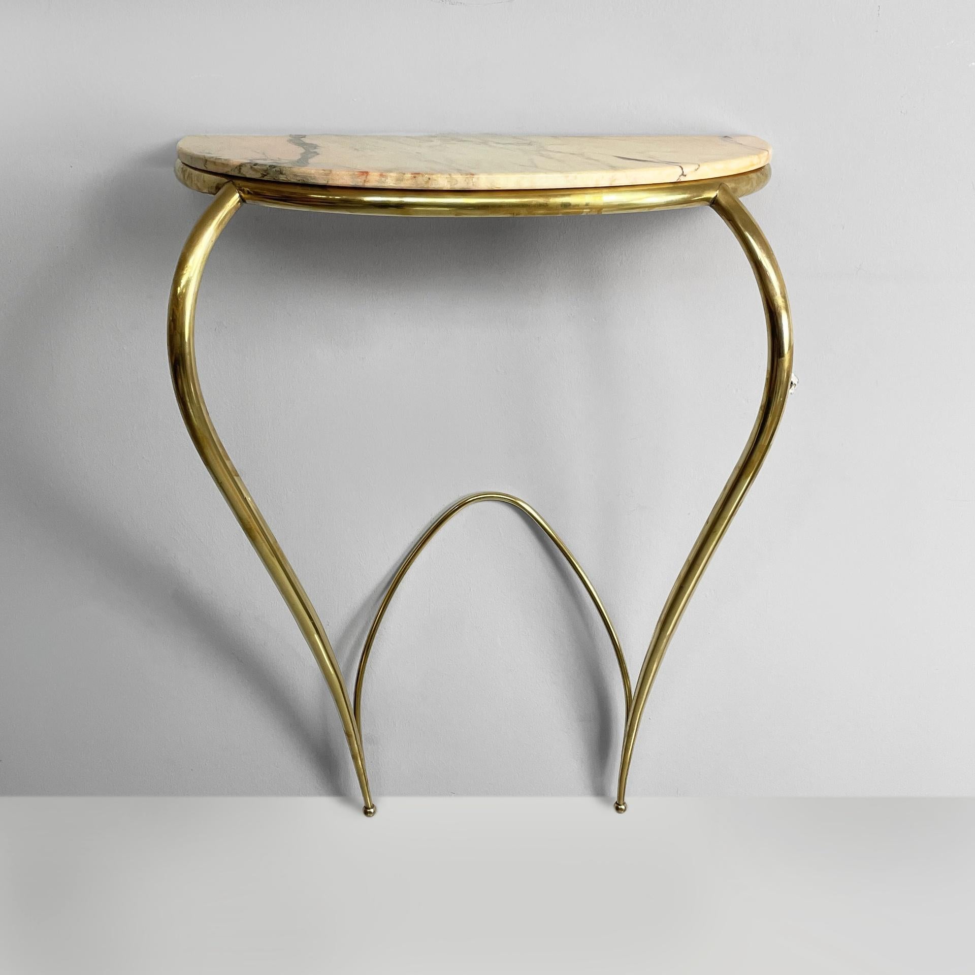 Italian mid-century modern brass and marble console by Carlo Enrico Rava, 1940s
Fantastic and vintage wall console with semi-oval top in pink marble. The structure on which the top rests is in tubular brass. The round section legs in brass have a