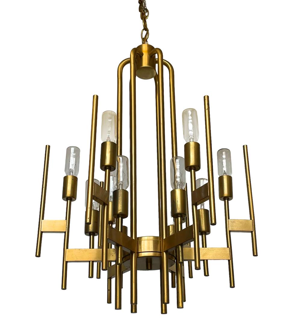 An early 1960's chandelier designed by Gaetano Sciolari for Sciolari Lighting. Nice vintage condition with some warm dark spot to brass. Appropriate bulbs included with some extra replacements. Tested & working. 