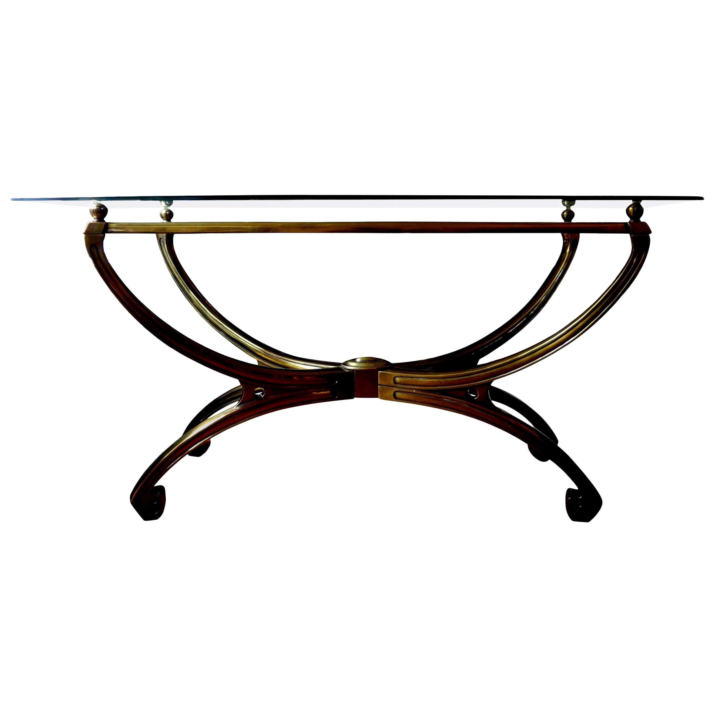 Italian brass console table in the manner of Romeo Rega. This stunning Italian mid century brass console table has Greek key feet and brass spheres supporting beveled glass top. This vintage brass console is free standing and inspired by the work of