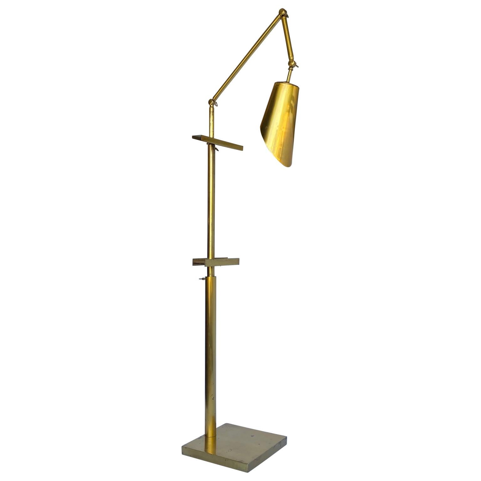 Large brass easel floor lamp in the style of Angelo Lelii, circa 1960's, Italy.
Easel has a rosewood panel for the painting to stand on.

The easel lamp is newly rewired to US standard and in good sturdy condition.