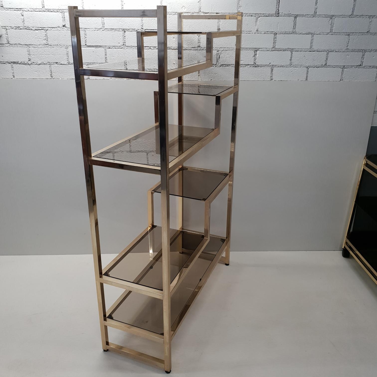 Brass shelving unit etagère with smoked glass.
With adjustable feet under the frame.
Italian design from the 1970s.
In style of Willy Rizzo, Romeo Rega.