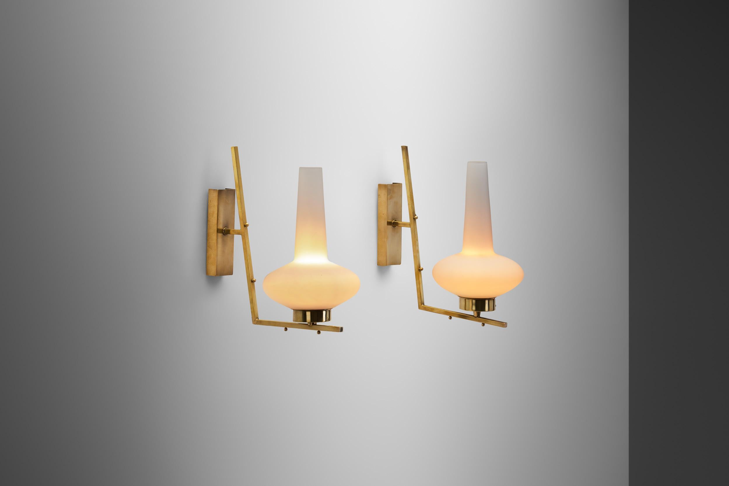 Italian Mid-20th Century lighting design was infinitely captivating, featuring one-of-a-kind models crafted by renowned Italian designers such as Ettore Sottsass, Gio Ponti, Gavina and other internationally esteemed names. As these wall lamps show,