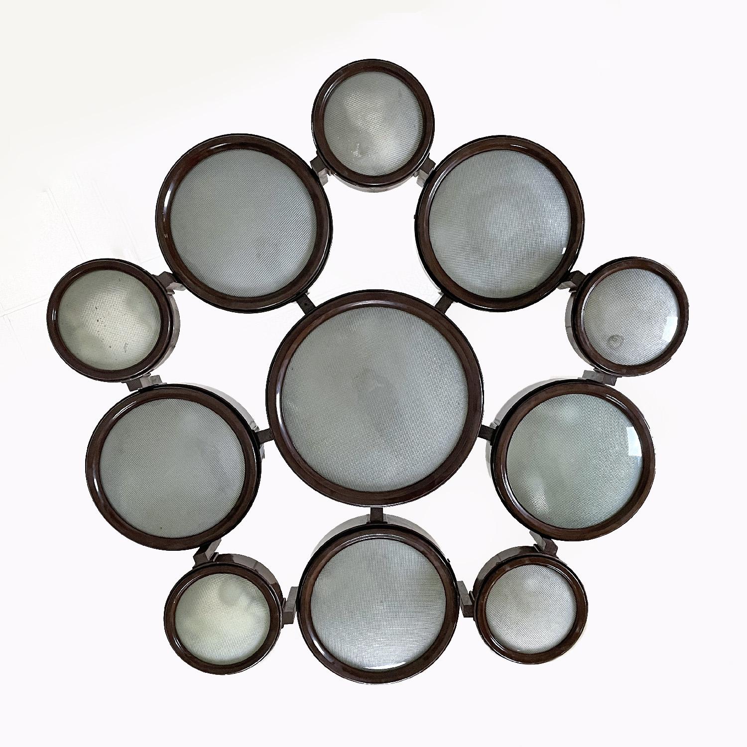Italian mid-century modern brown ceiling lamp 2045 by BBPR for Arteluce, 1960s
Ceiling chandelier mod. 2045 pentagonal in shape. It has a total of eleven speakers, six of which are larger and five smaller, differing in both circumference and height.