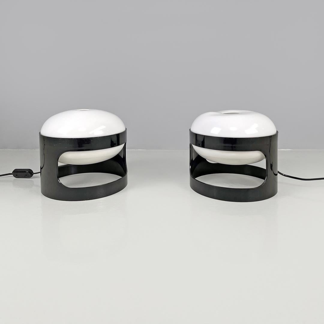 Italian mid-century modern brown plastic table lamps KD27 Colombo Kartell, 1960s
Pair of table lamps mod. KD27 in brown plastic. The cylindrical structure has a rectangular hole with rounded corners in the center, in the upper part the elliptical