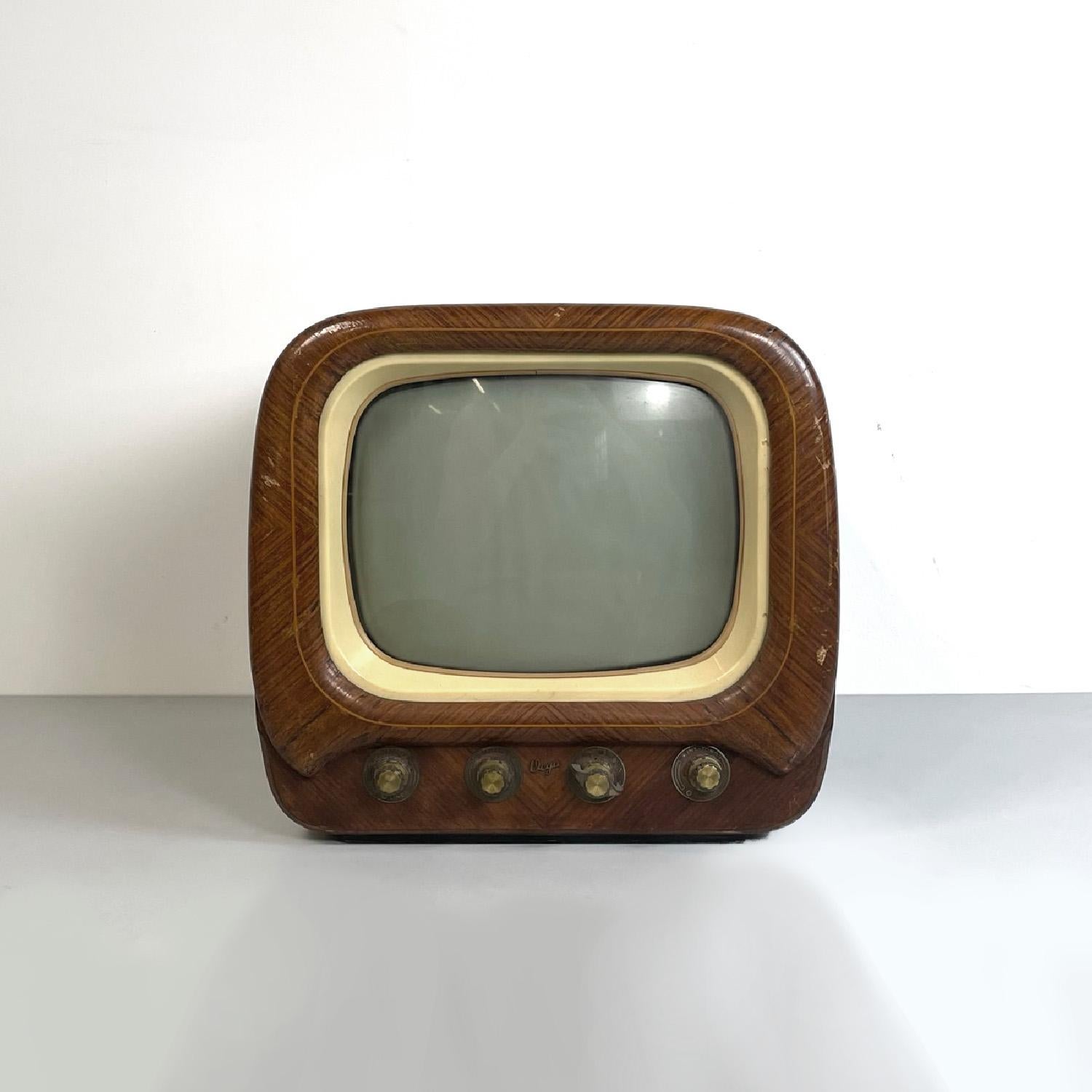 Italian mid-century modern brown wooden white plastic television by Vega, 1950s
Rectangular wooden television. The screen has rounded corners and a cream colored plastic frame, underneath are four knobs in plastic and brass. The wooden structure has