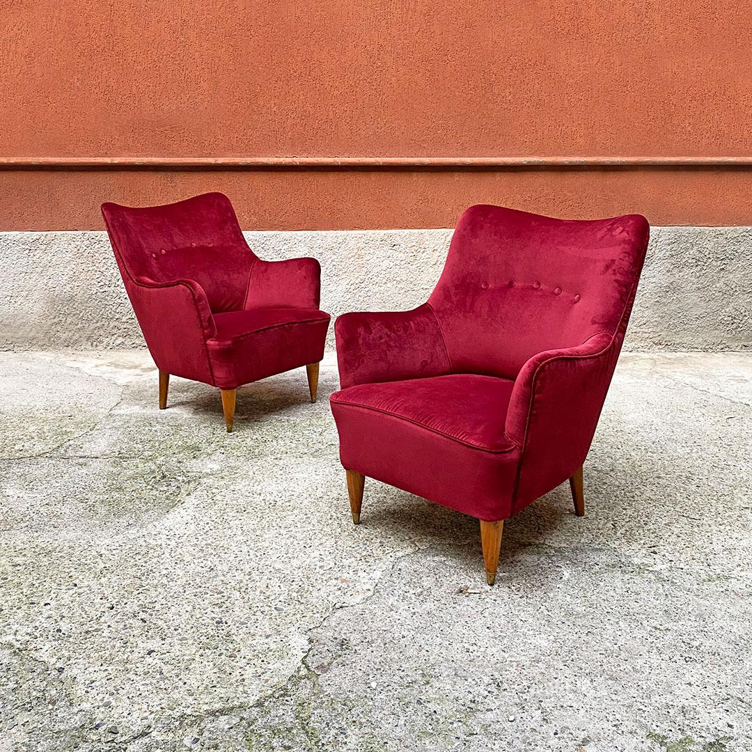 Italian Mid-Century Modern burgundy velvet and wooden armchairs, 1950s
Pair of armchairs with armrests covered in burgundy velvet, wooden legs with brass tips on the front ones.
1950s
Excellent condition, with new padding and new cherry