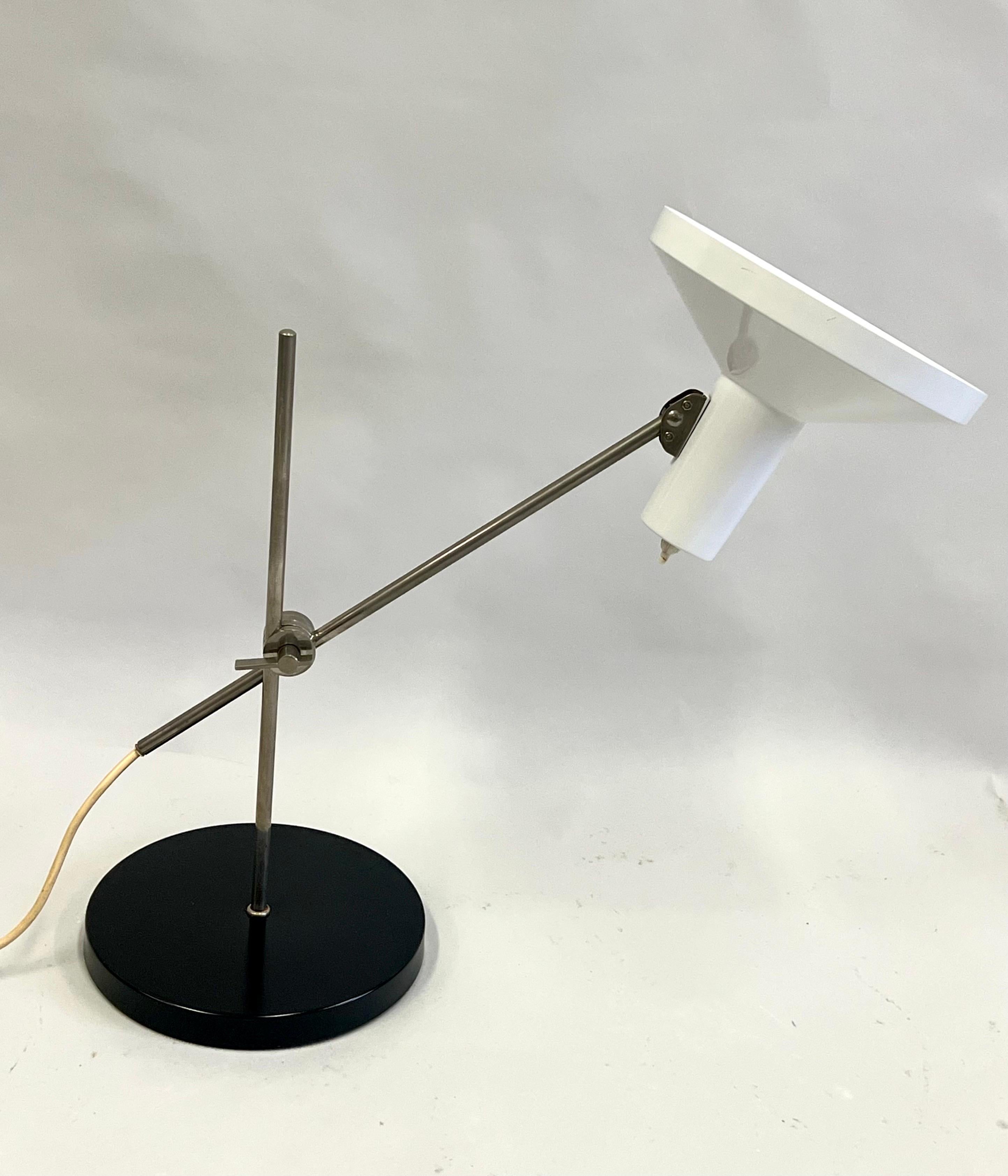 An original, daring Italian Mid-Century Modern table lamp circa 1950 attributed to Arredoluce and Angelo Lelli. This elegant and rare piece displays the timeless aesthetics, balance and engineering that Italian Design is known for. A minimalist