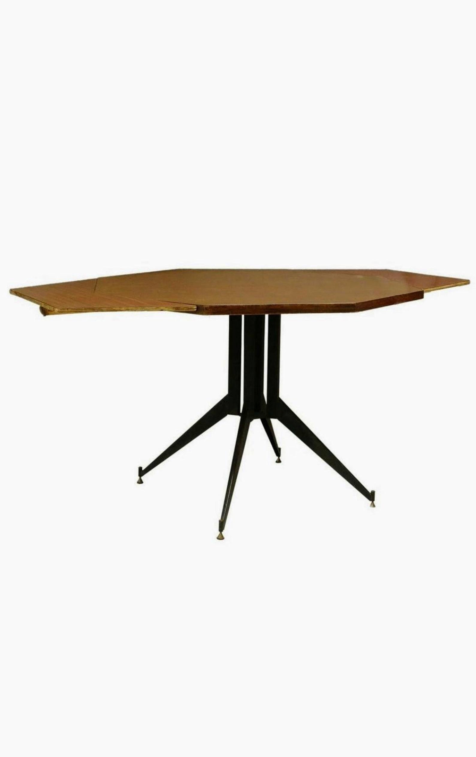 A Mid-Century Modern dining / center table, Italy, circa 1960s, having a laminate octagonal tabletop, rising on an iron pedestal base, accompanied by a pair of angular leaves. Attributed to Italian Modernist designer Carlo Ratti.

Dimensions: