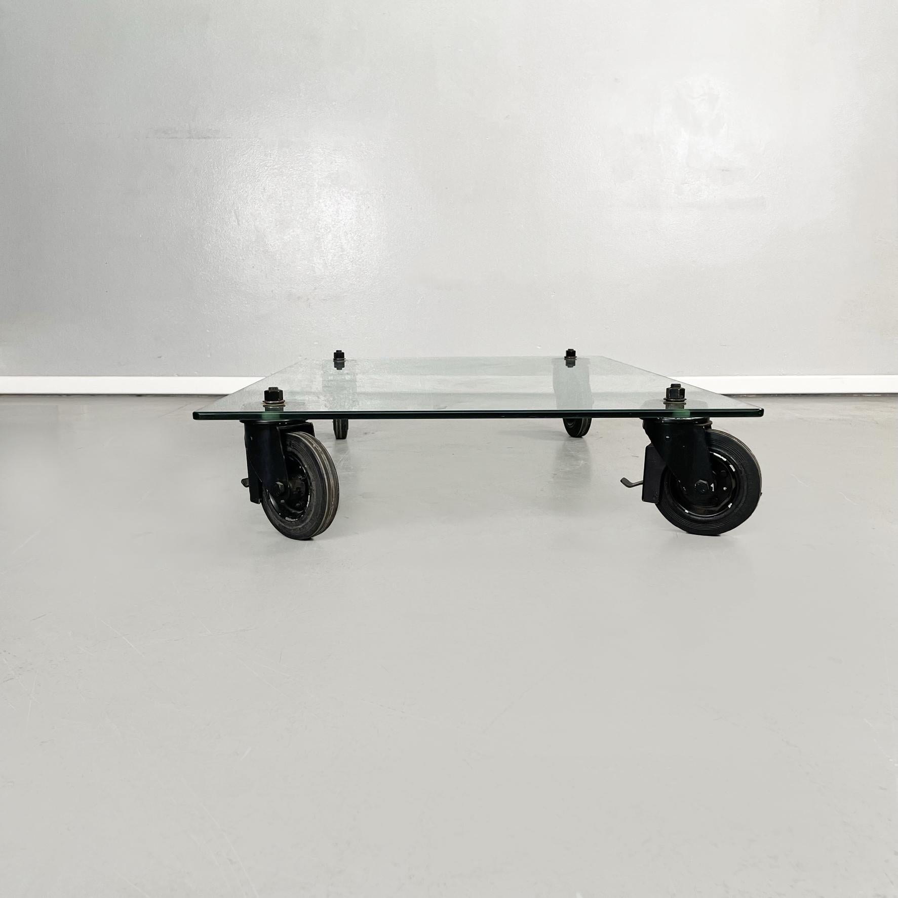 Italian Mid-Century Modern Coffee table by Gae Aulenti for Fontana Arte, 1980s
Coffee table on wheels with rectangular top in aquamarine green glass, with rounded corners. The top is supported by 4 thick industrial wheels in black painted metal.