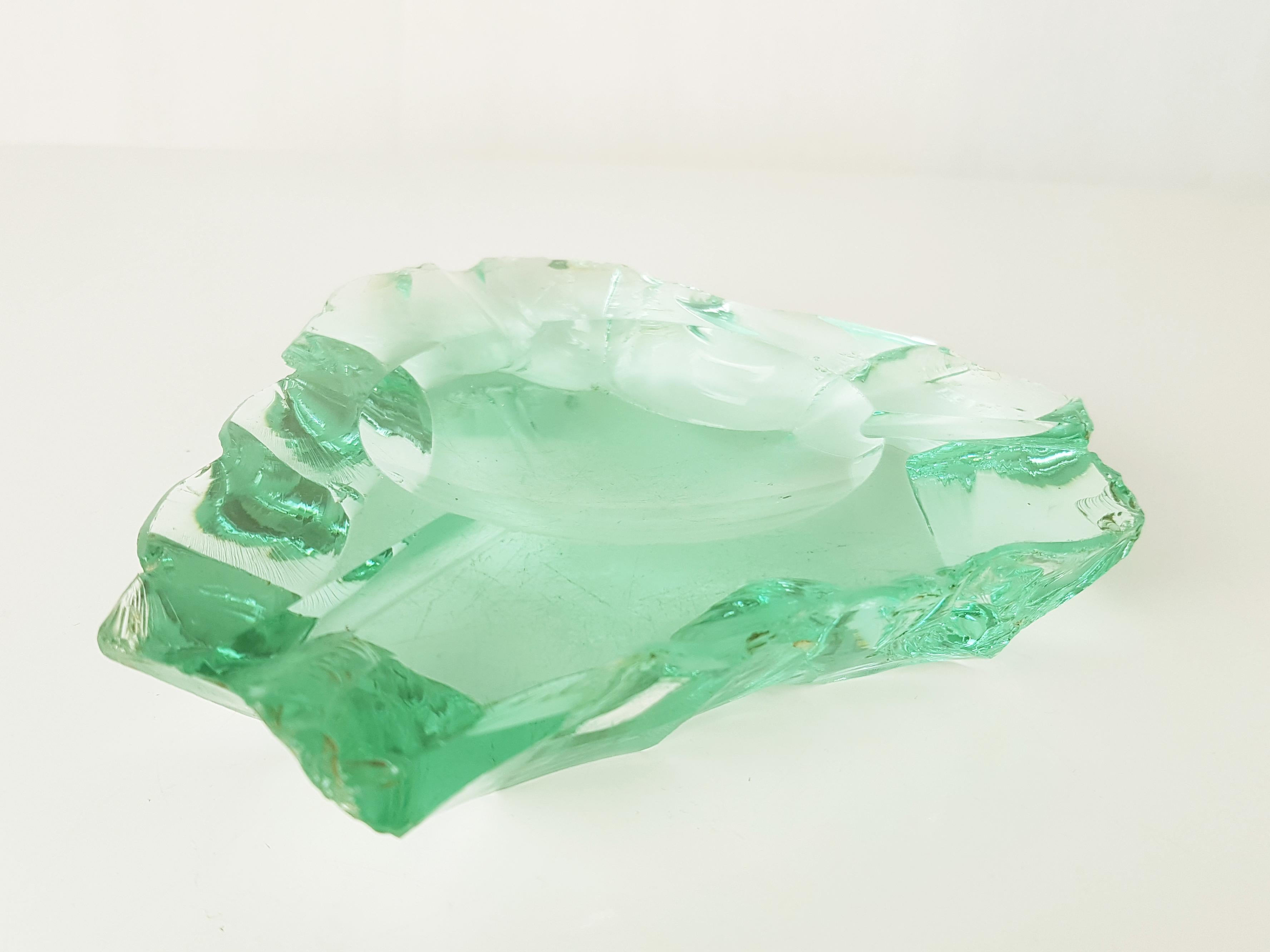 Ashtray in carved and ground glass of strong thickness. Rustic workmanship with chippings typical of Pietro Chiesa's productions in the 40s/50s.
Conditions as per photo: visible scratches on the base.