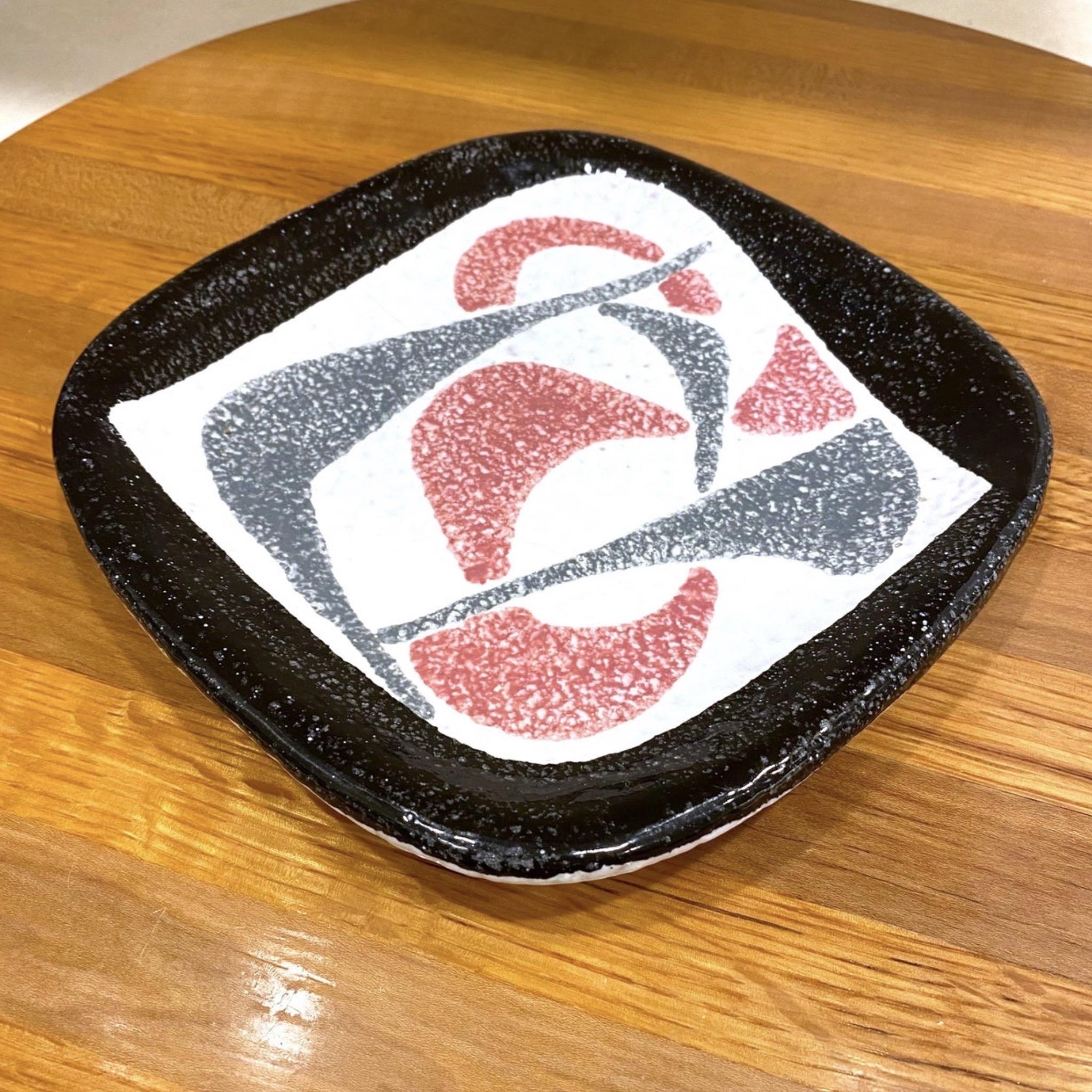 A fantastic ceramic atomic style plate with black and gray and pink boomerangs. The square plate has rounded edges. Marked Italy on the bottom. In the style of Fratelli Fanciullacci.