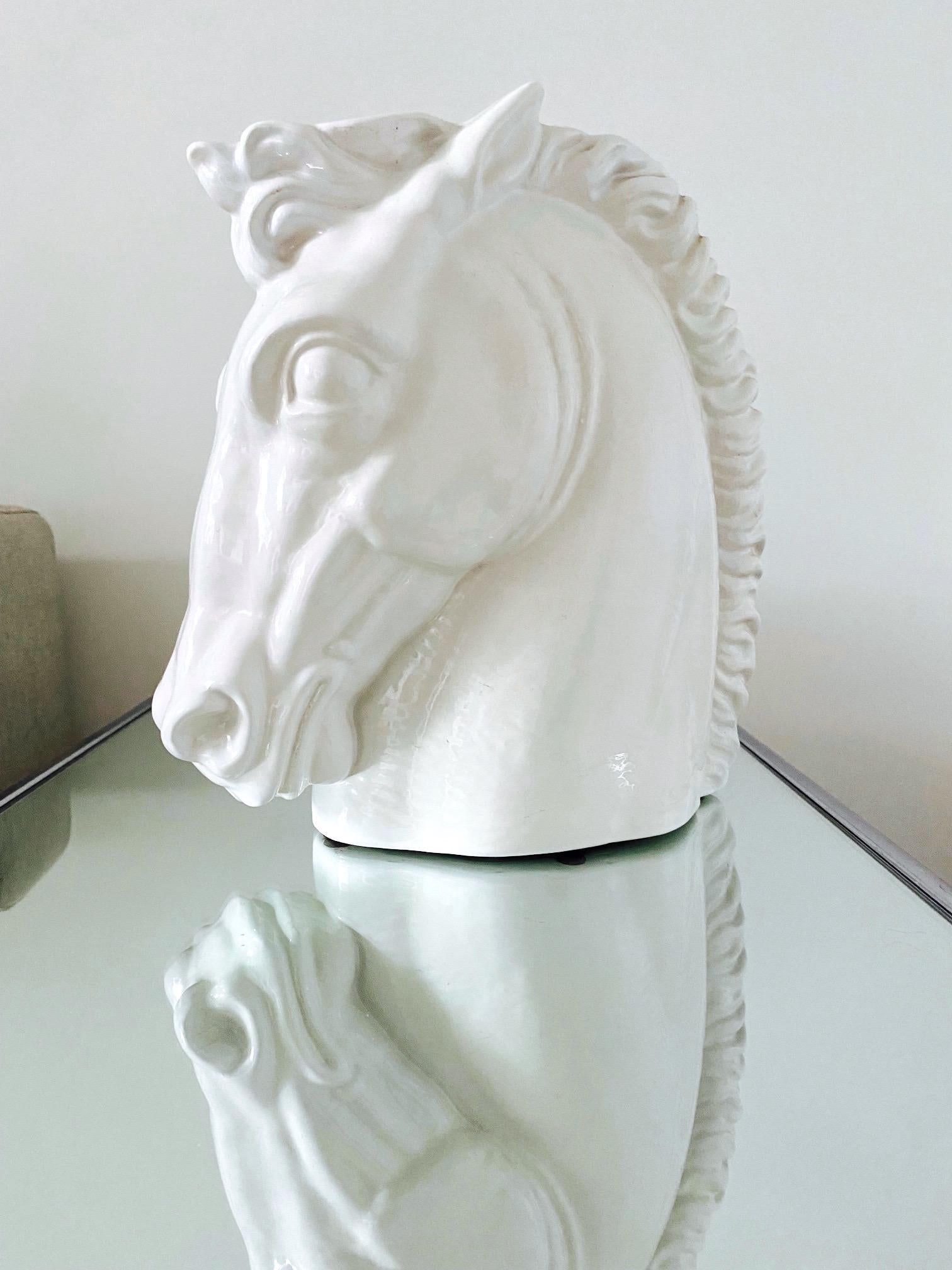 1970's Italian bust of a horse head with a white glazed finish. The handcrafted stallion has a realist features inspired by the highly stylized details of the Art Deco Era. The striking piece is beautiful from all angles. It can be used as a