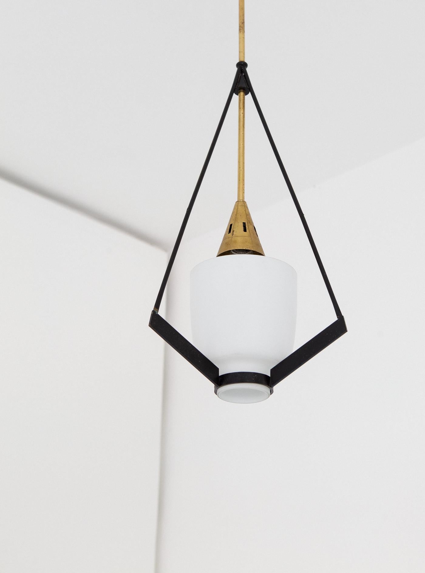 Mid-Century Modern pendant lamp manufactured in Italy during the 1950s.
The ceiling light feature black enameled iron with opaline glass and also brass parts
Original working wire with standard E27 bulbs, you can request to replace the original