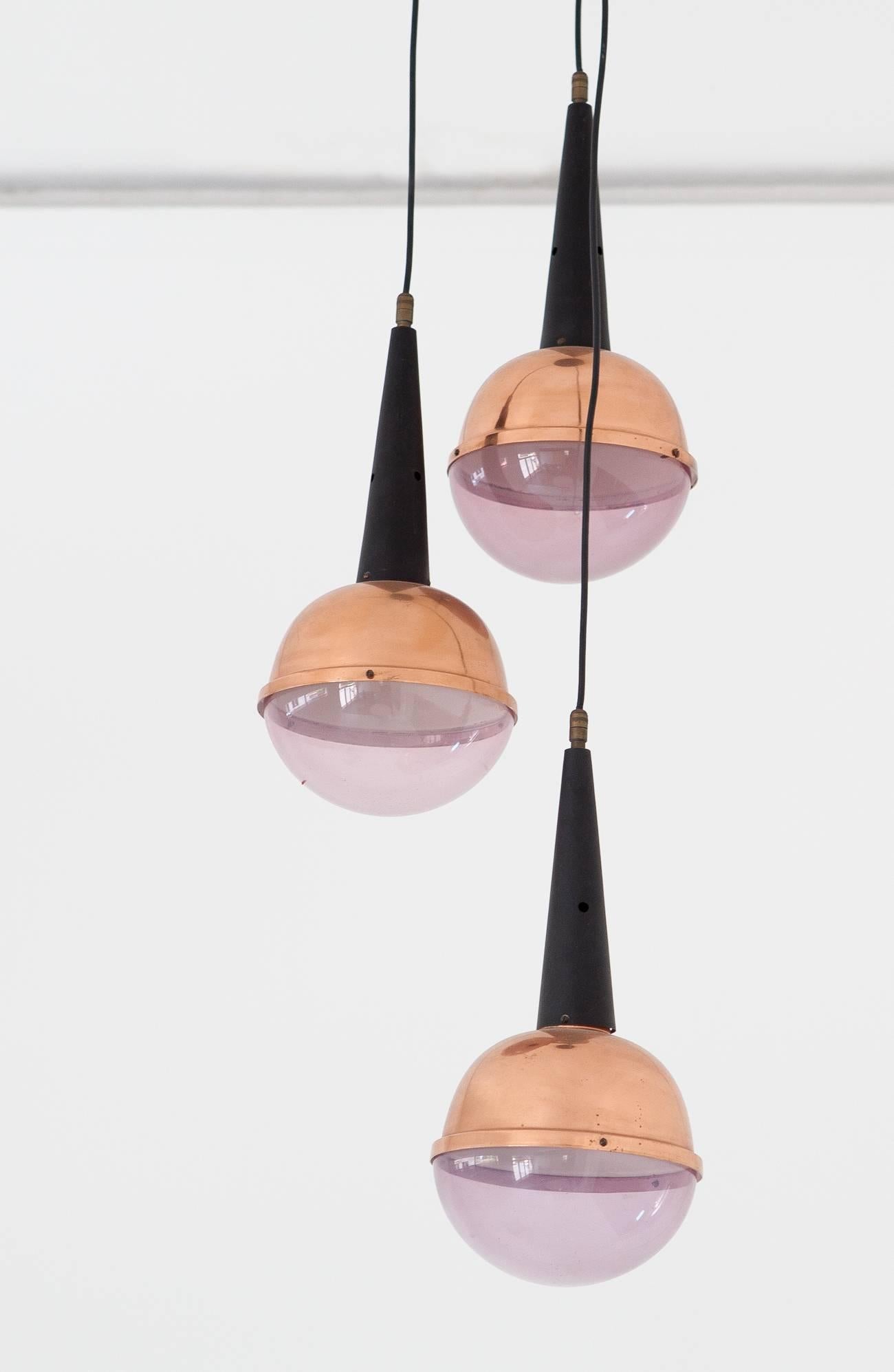 Modern pendant lamp manufactured in Italy during the 1960s.
The ceiling light feature black enameled iron with bronze and Perspex globes and brass details
Original working wire with standard E27 bulbs, you can request to replace the original with