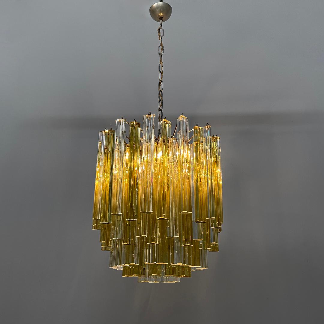 Italian mid-century modern chandelier Triedri in Murano glass by Venini, 1960s
Chandelier mod. Tredri in yellow and transparent Murano glass. The chandelier is composed of five concentric rows of prisms with an elongated triangular glass base. The