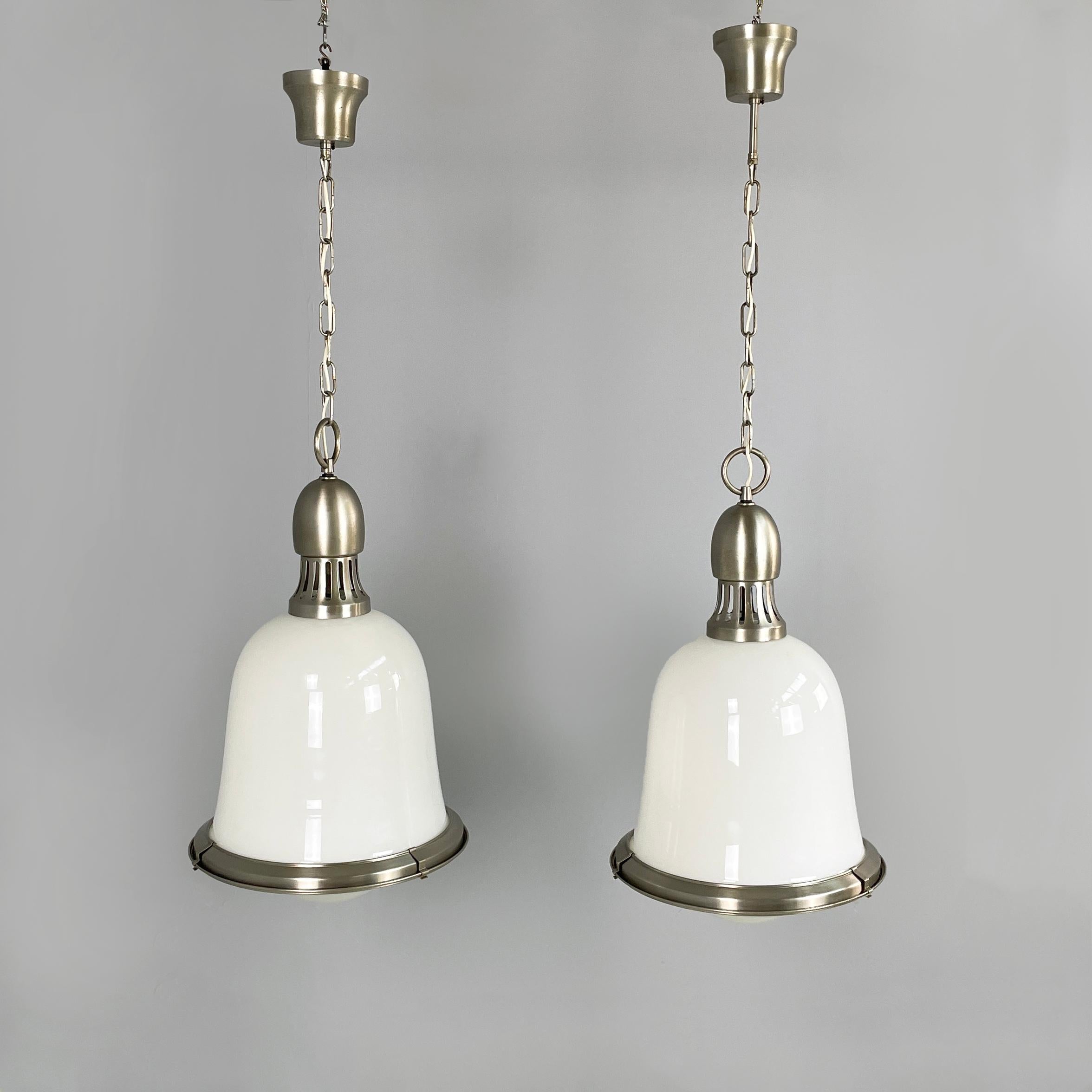 Italian mid-century modern Chandeliers in opaline glass and metal, 1960s
Pair of round base chandeliers in metal and opaline glass. The diffuser has a bell shape with a rounded part underneath and a metal profile. The structure is composed of a