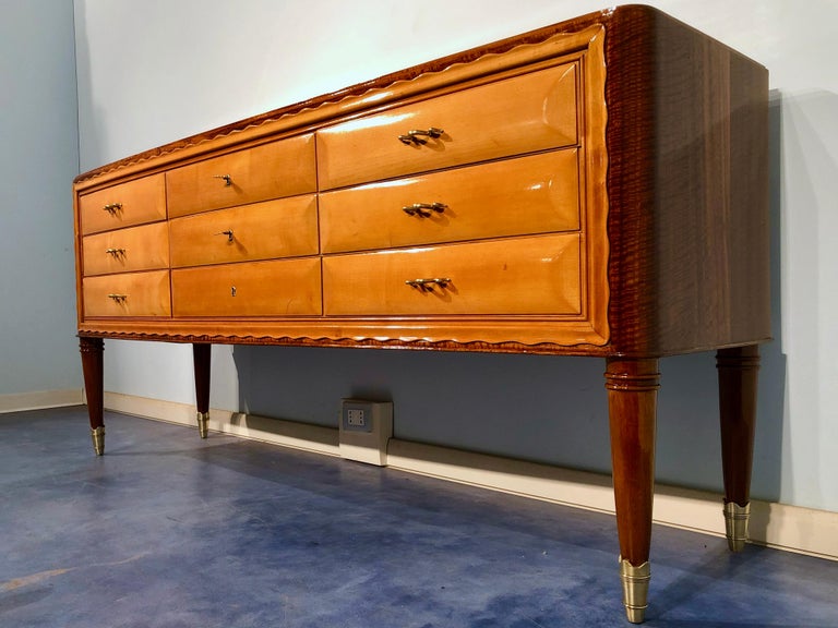 Wonderful Italian sideboard or chest of drawers designed by Paolo Buffa in the 1950s. Truly refined the used wood combination in maple for the drawers and walnut for the furniture rest. The beauty of the walnut flame design placed on the top and