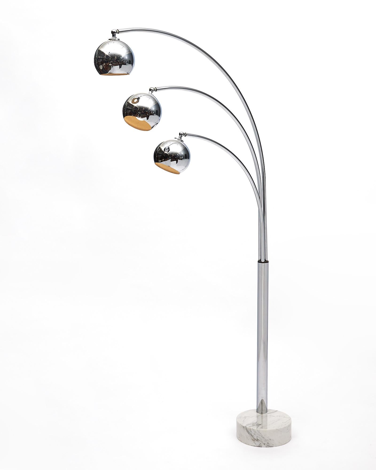 Arc floor lamp, Italian, from the mid-century made of chromed steel with a Carrara marble base. This piece is by Guzzini. It has been newly wired to fit US standards. The diameter of the base is 11.75”.