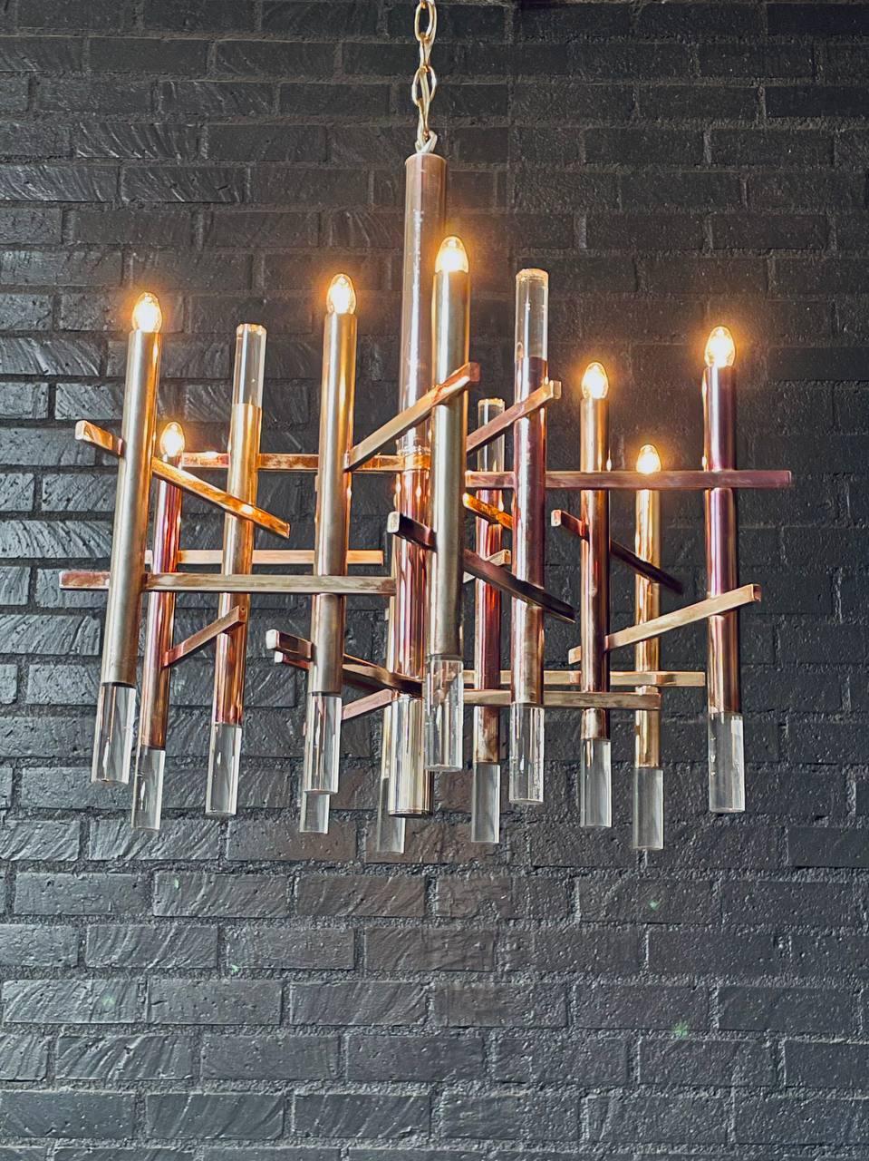 Condition: Original Vintage Condition, Shows Wear Throughout, Turns On 
Materials: Patinated Chrome & Lucite

A striking example of Italian modernist design, this Mid-Century Modern chandelier by Gaetano Sciolari features a dynamic composition of