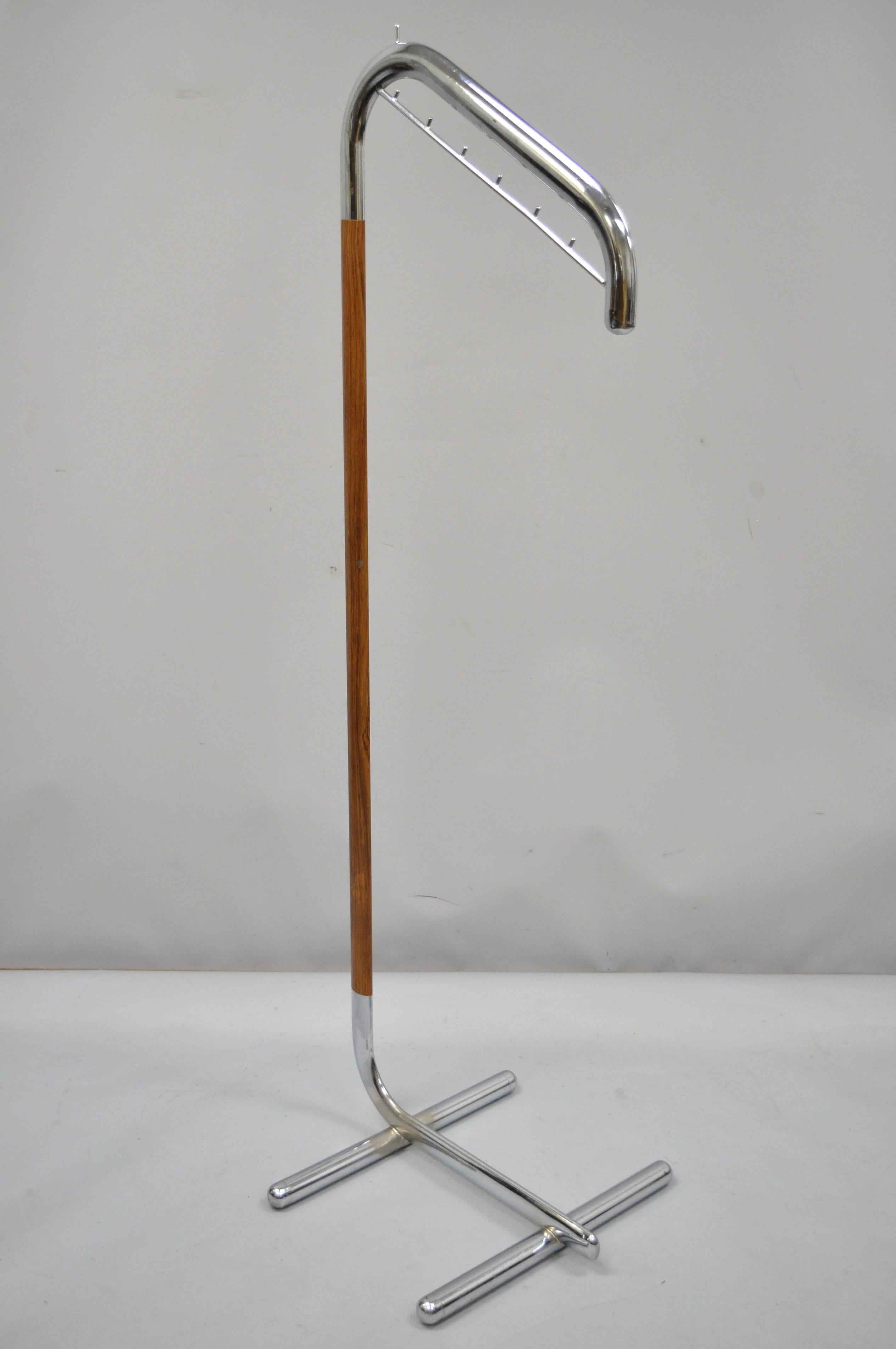Vintage Italian Mid-Century Modern chrome metal clothing rack clothes valet hanger (A). Item features sleek metal construction, faux wood grain laminated wrapped shaft (not wood), cantilever style frame, various hooks, very nice vintage item, great