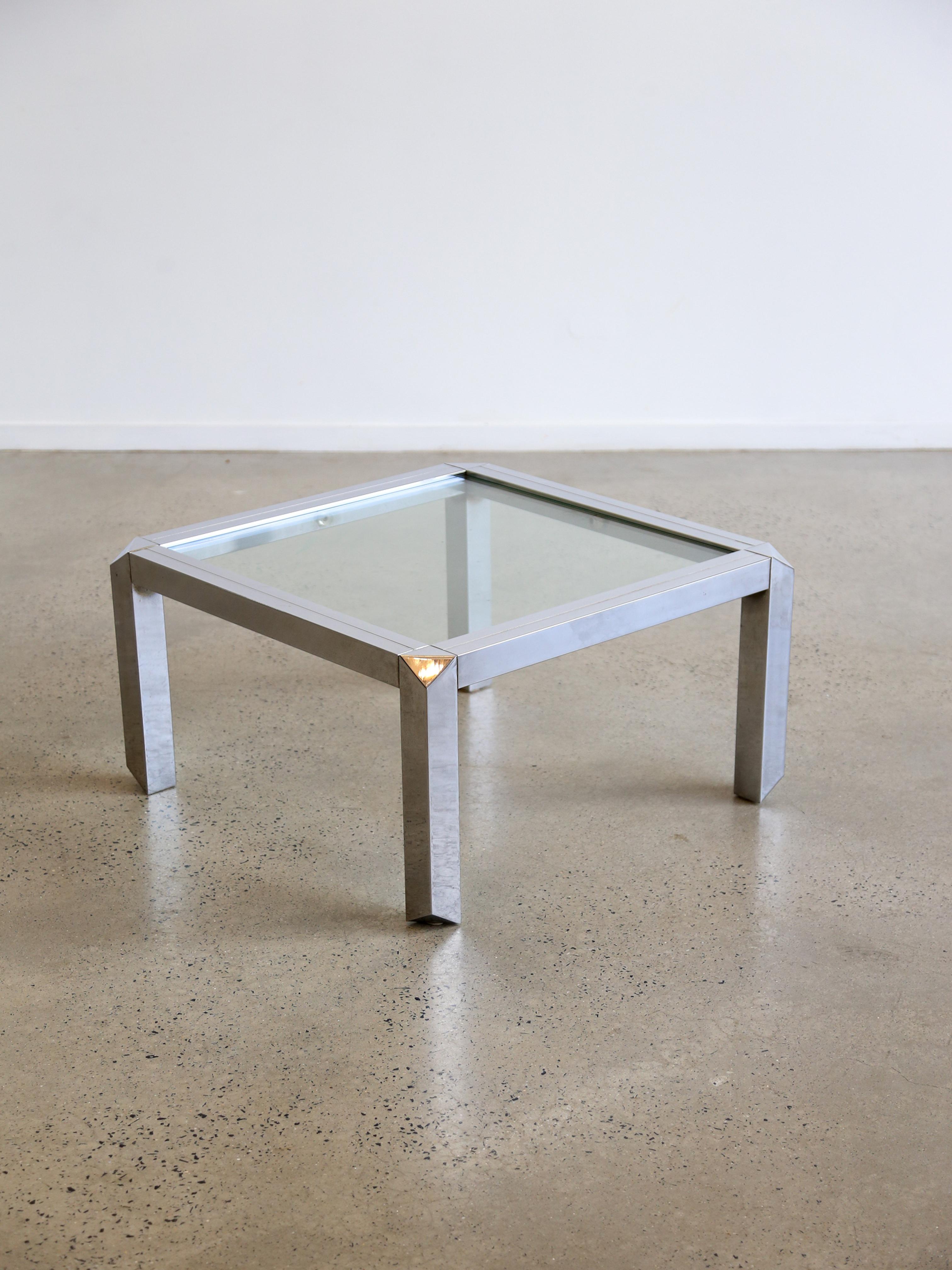 Mid-century modern design often incorporated geometric shapes, and a square coffee table is a good example of this. The square shape gives the table a symmetrical and balanced look.

The use of chrome or polished metal frames is a common feature in