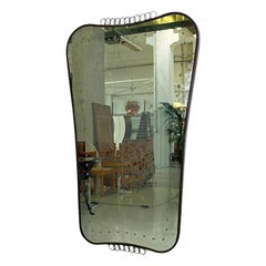 Italian mid century modern coat-of-arms-shaped burnished brass wall mirror, 1950s