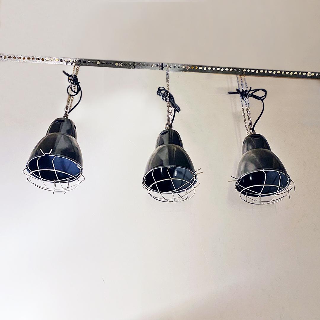 Italian Mid-Century Modern dark gray industrial metal chandeliers, 1960s 
Dark gray industrial chandeliers in enamelled metal with metal grille and chain for suspension.

Good condition, rewired system.

Measures: 20 x 35 H cm.