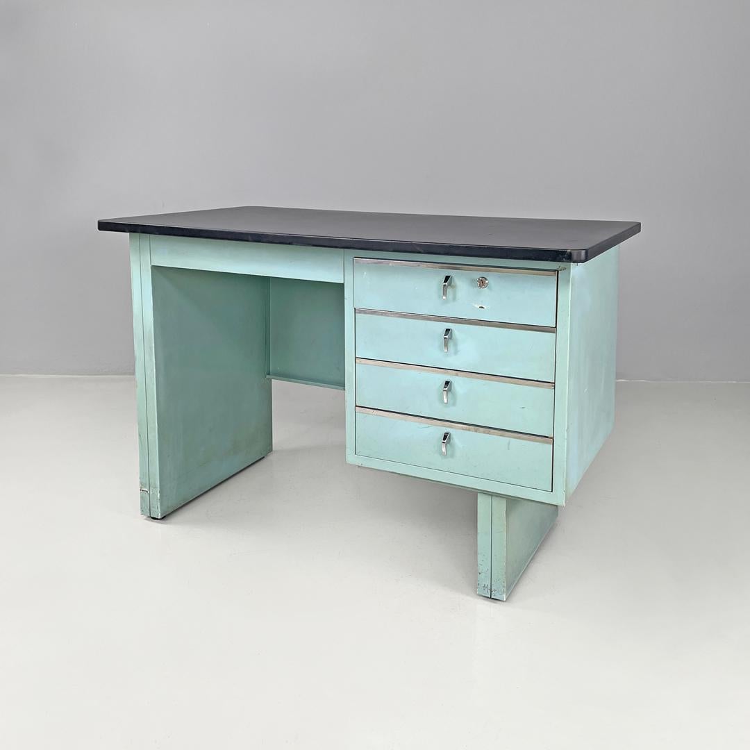 Italian mid-century modern desk in light blue metal and black leather top, 1960s
Desk with rectangular top covered in black leather. The structure is in light blue painted metal and has four drawers with working keys. The drawers have chromed metal