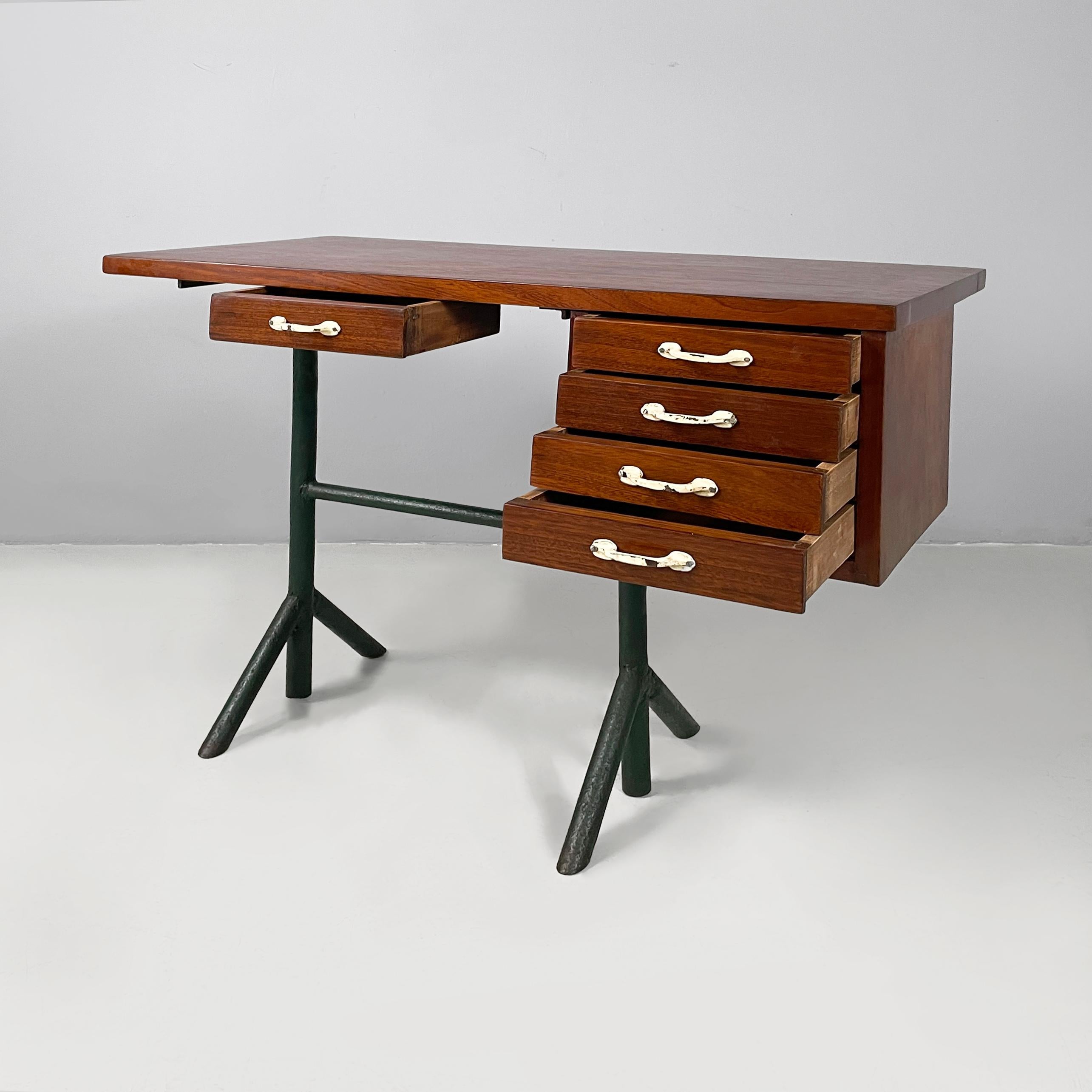 Italian mid-century modern desk in wood and metal, 1960s
Desk with rectangular wooden top. In the center of the top there is a wooden drawer with white painted metal handle. On one side there are four rectangular drawers with a cream white painted
