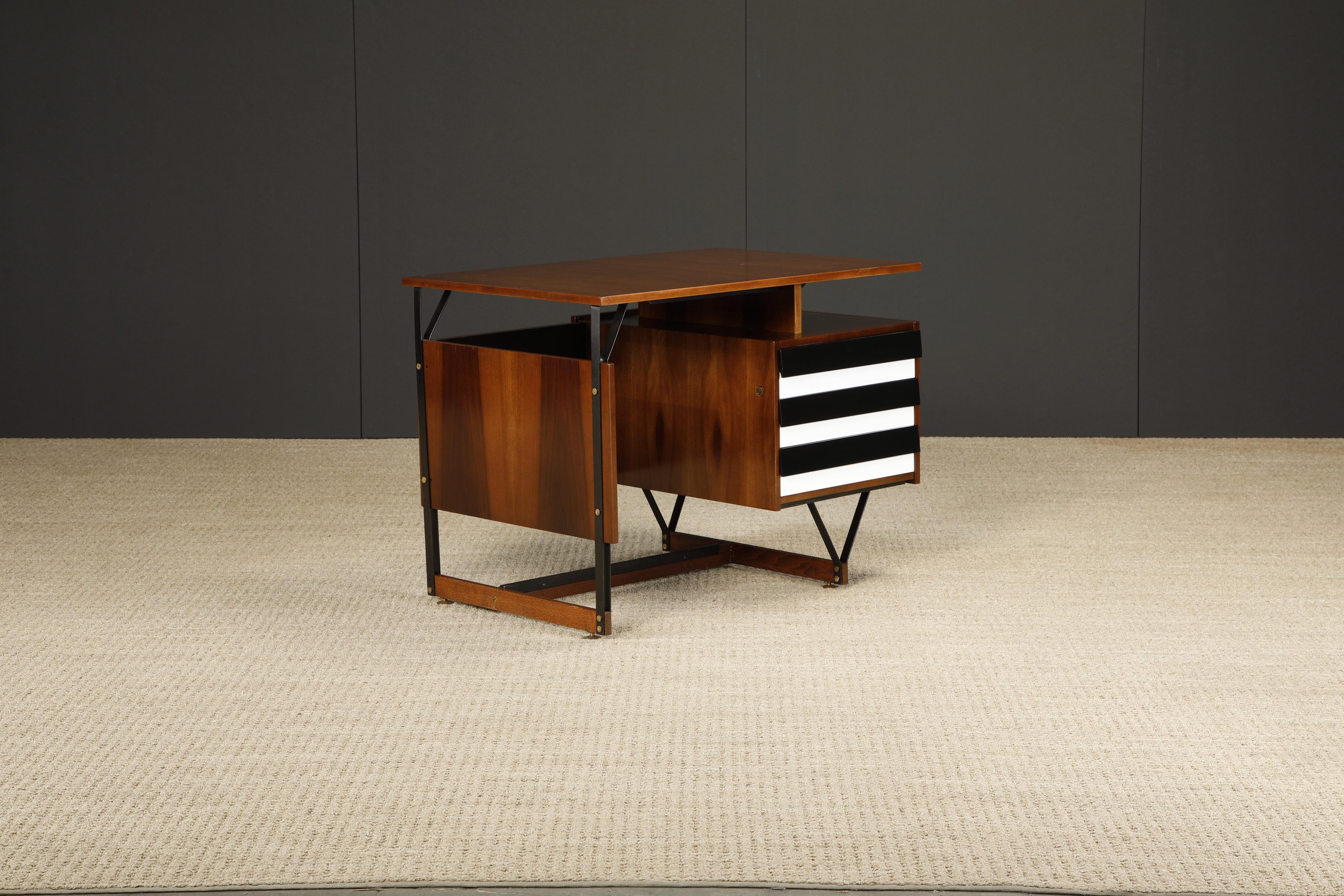 Beautifully refinished Mid-Century Modern desk produced in Italy circa 1950s. Featuring black steel and wood frame with large brass elements and alternating black and white drawer fronts. 

This design has been previously attributed to Ico Parisi