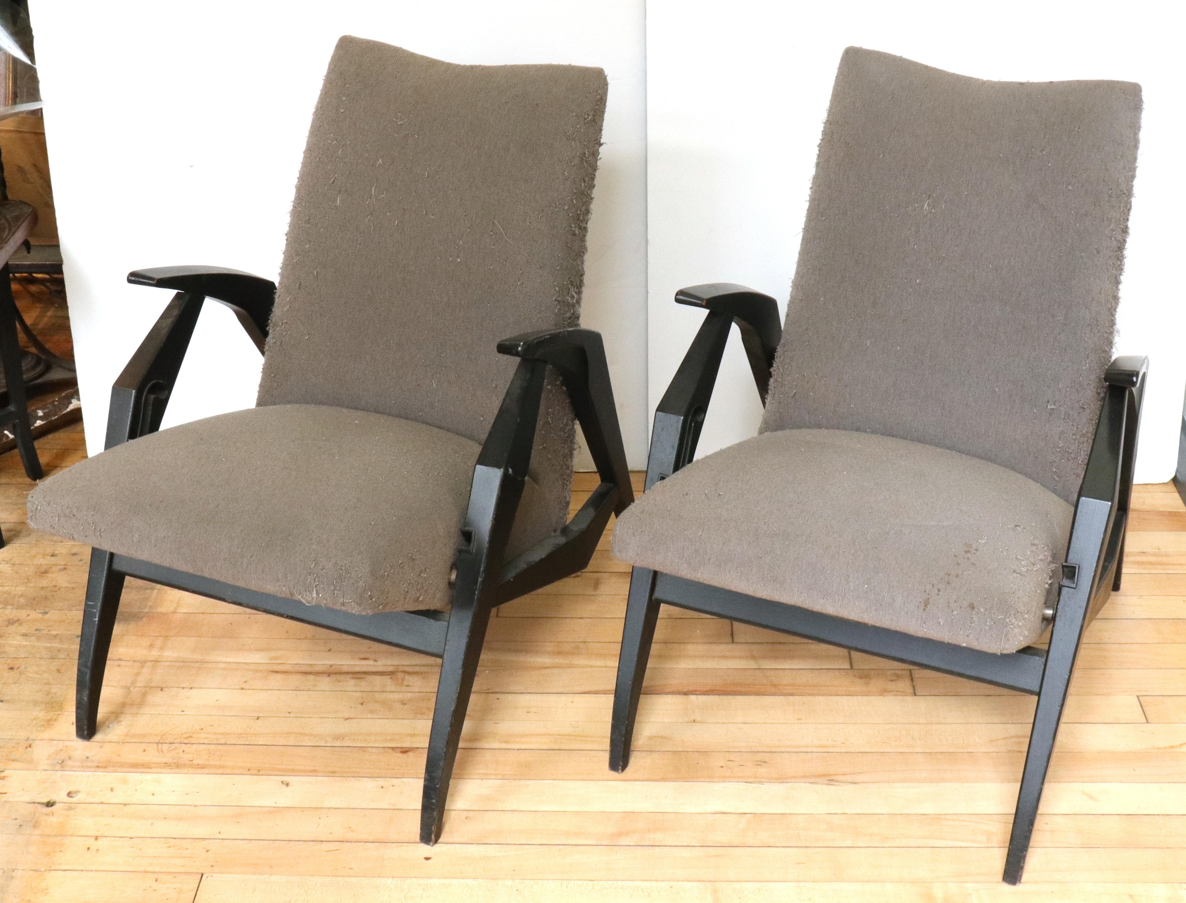 Italian Mid-Century Modern pair of diminutive reclining adjustable armchairs with a lacquered wood structure and in original upholstery. The pair switches from upright into a reclining position and was made in Italy during the 1950s. In great