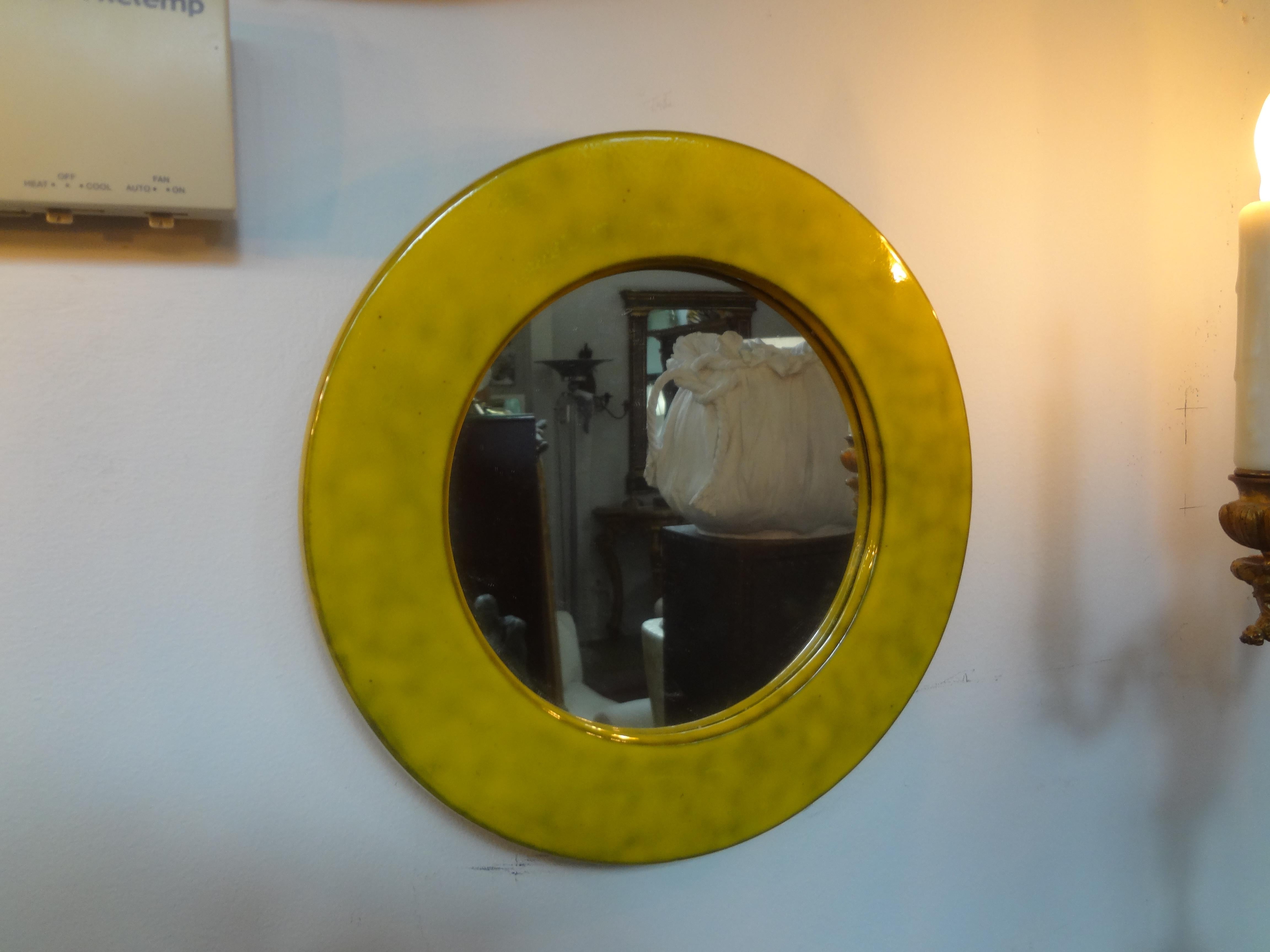 Italian Mid-Century Modern enamel mirror. This stunning mirror is a beautiful shade of yellow and would look great alone or grouped with a variety of other mirrors.