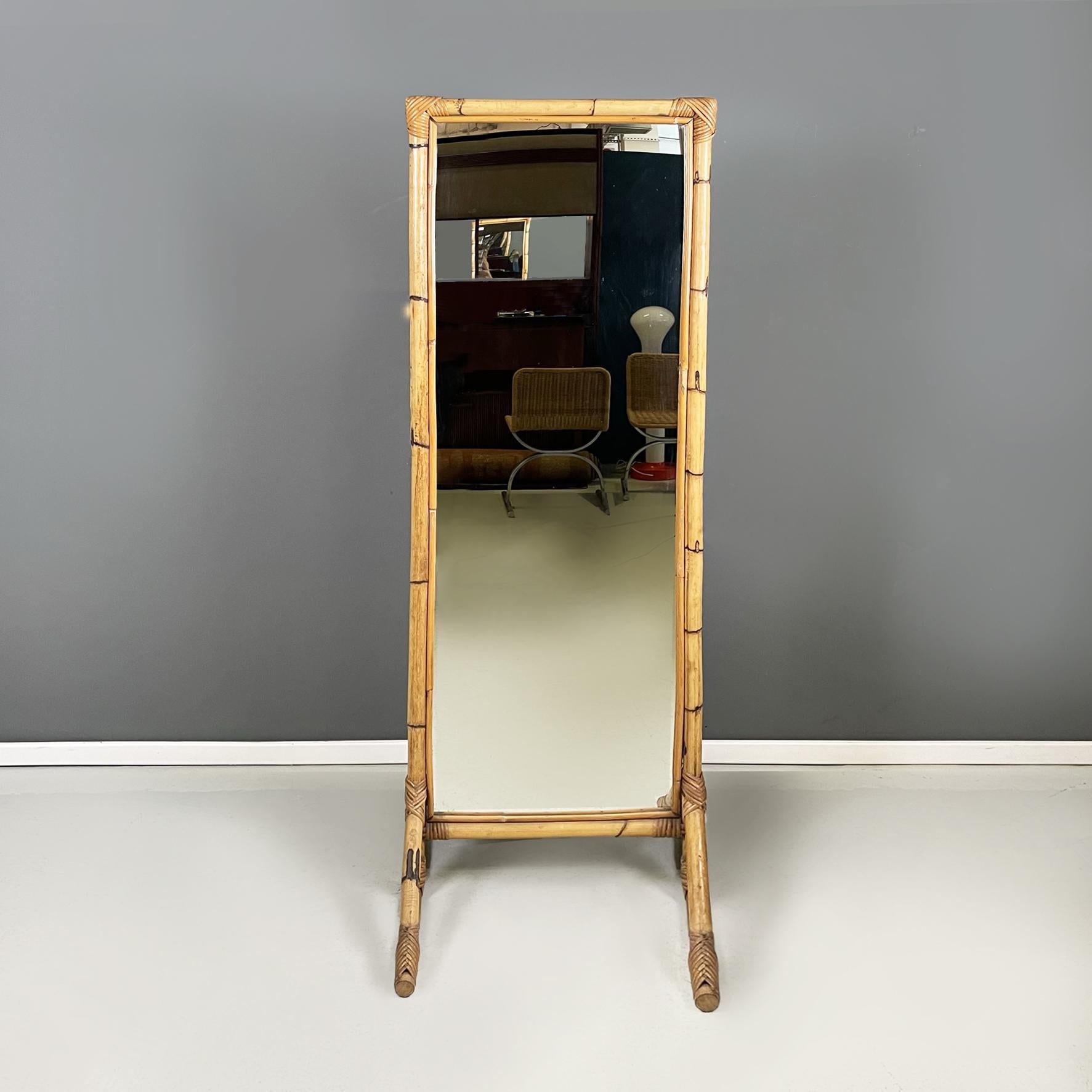 Italian mid-century modern Floor freestanding full-length rattan mirror, 1960s
Full-length rectangular self-supporting floor mirror, with rattan structure. It features woven detailing at the corners. The two rattan legs are triangular in shape. The