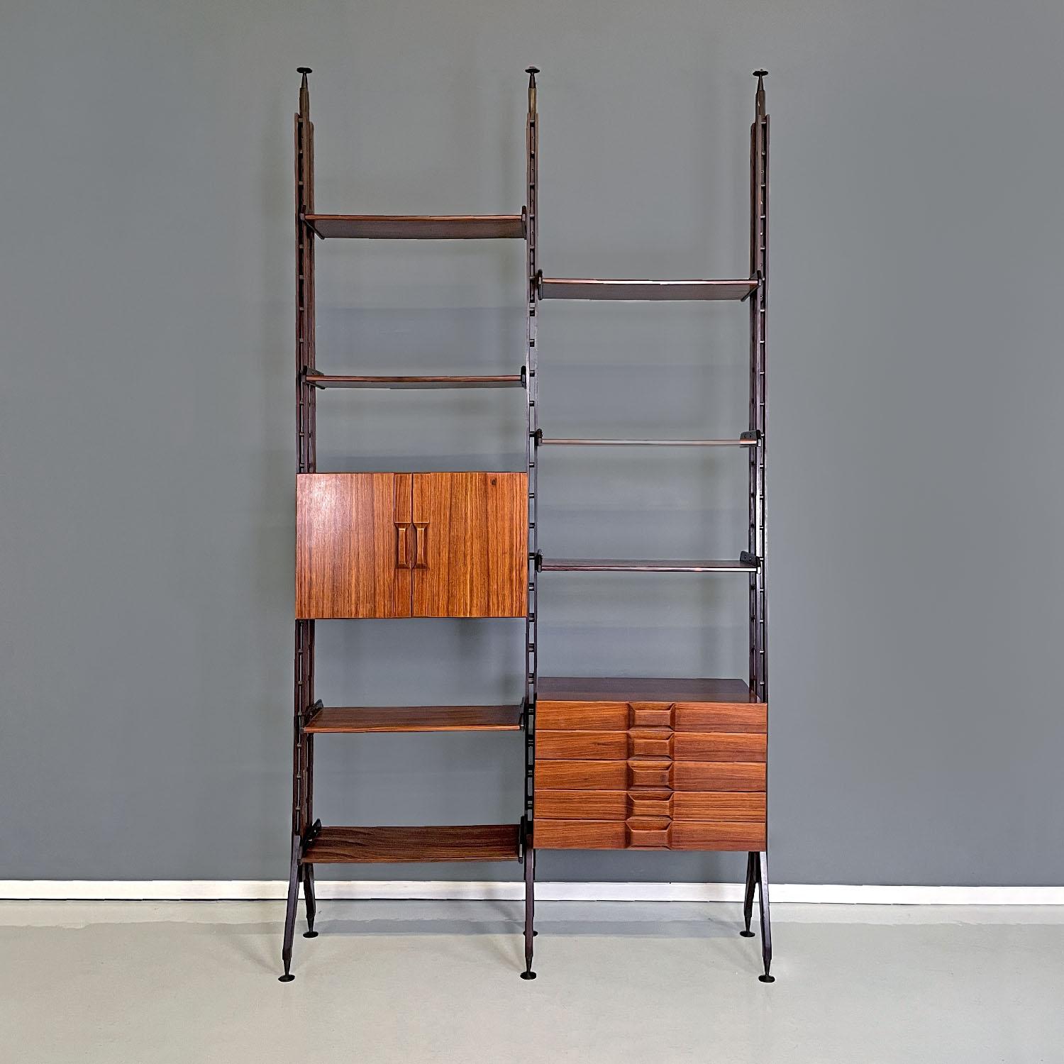 Italian mid-century modern floor-to-ceiling wood and brass bookcase, 1960s
Free-standing bookcase with wooden and brass structure, composed of two spans. Inside the uprights there are brass tracks that allow you to arrange the two modules and the