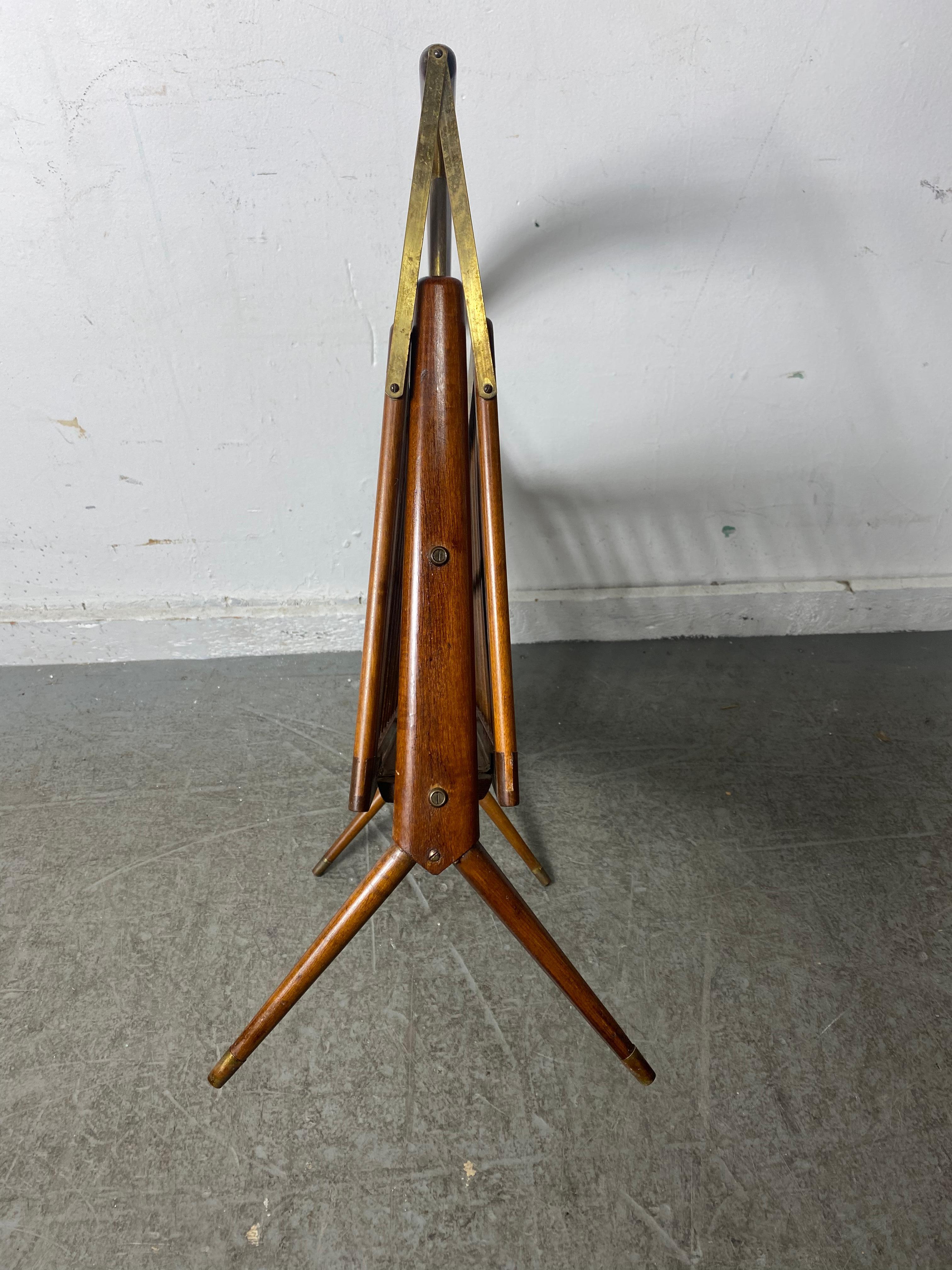 Italian, Mid-Century Modern, walnut and brass, magazine holder by Cesare Lacca folds up from it's handle for mobility, Ingenious design.