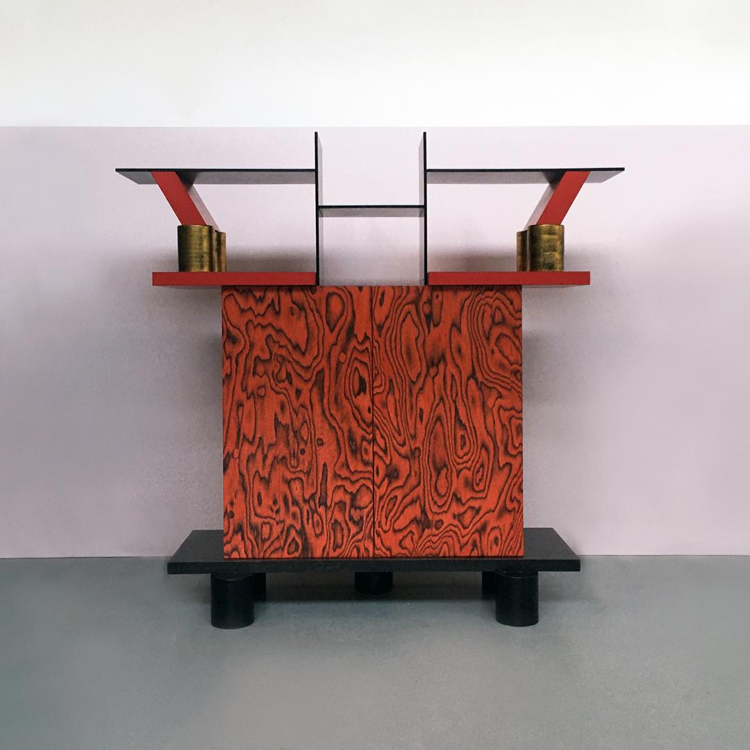 Italian Mid-Century Modern Freemont cabinet by Ettore Sottsass for Memphis, 1985.
Wooden cabinet Freemont with 5 black cylindrical legs and container in painted wood. The upper part is a bookcase, and is characterized by a laminate coating in red