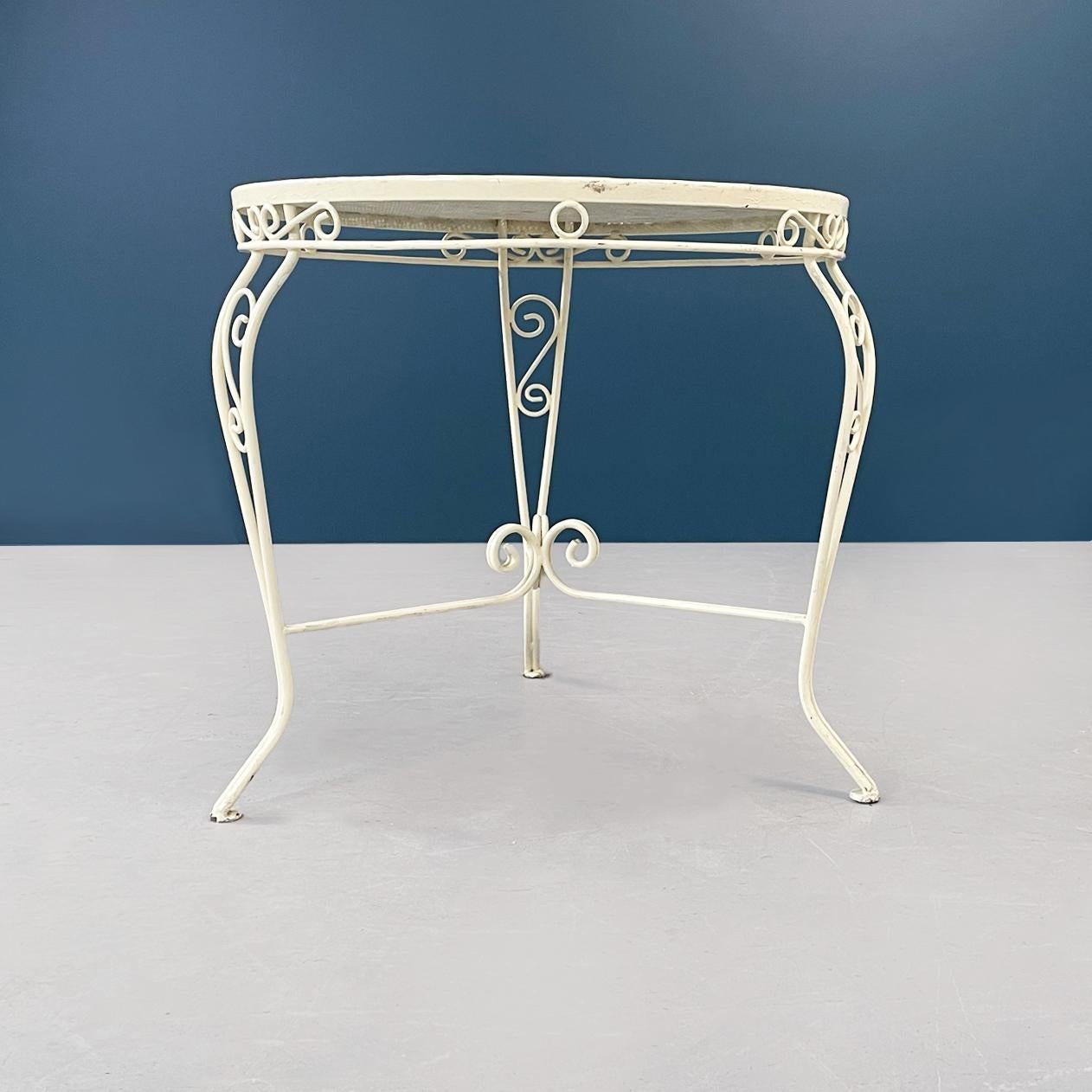 Italian Mid-Century Modern garden table in white wrought iron, 1960s
Garden table in cream white painted wrought iron.
The round top is perforated to consent the use in outdoor
The edge of the top and the three legs are finely worked with curls and