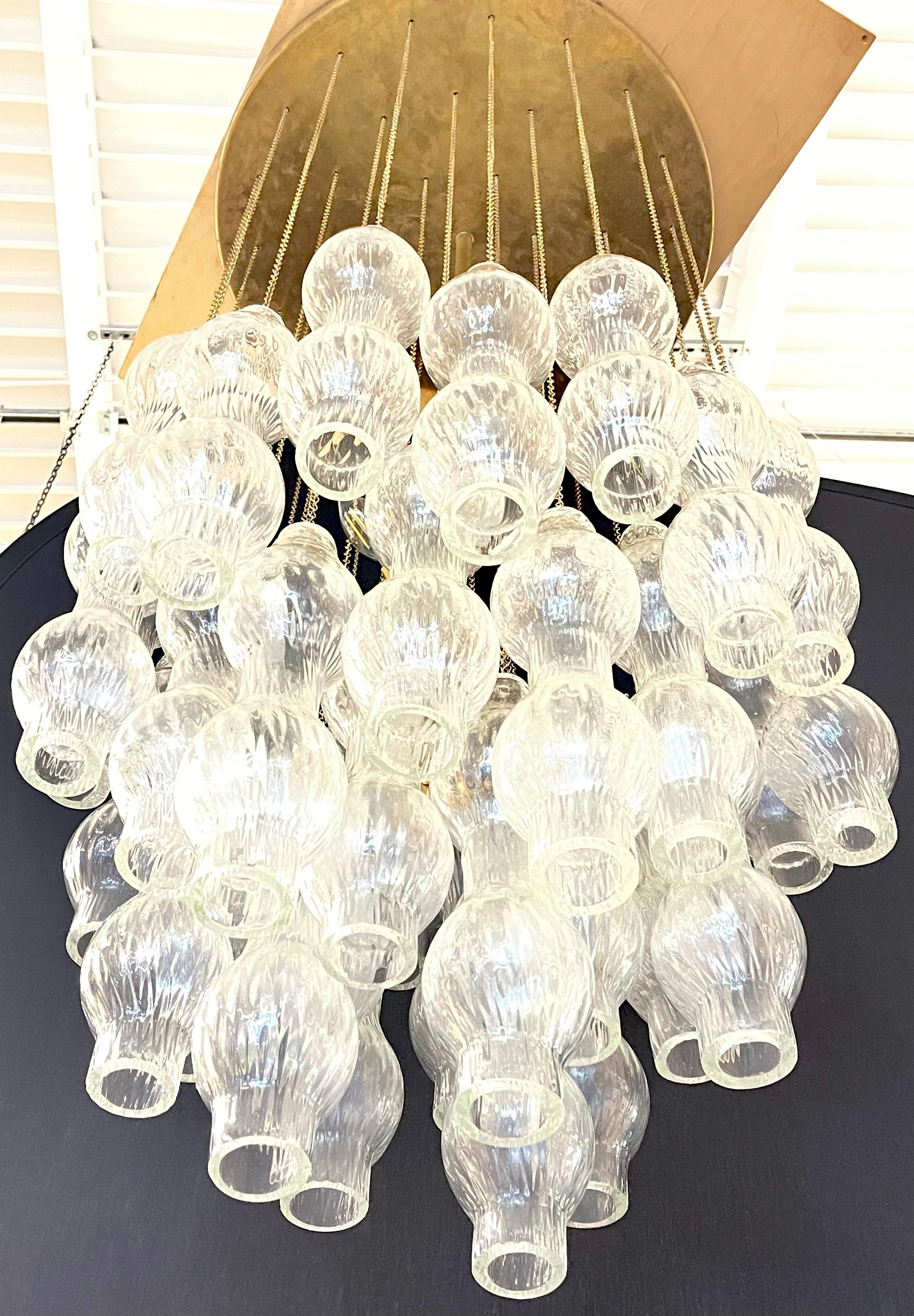 Mid-Century Modern glass chandelier having a myraid of bolbous form hanging flutes. Made in Italy circa 1950s. 

This is part of our extensive collection which just arrived from Chicago's renowned interior designer Megan Winters. Megan and her