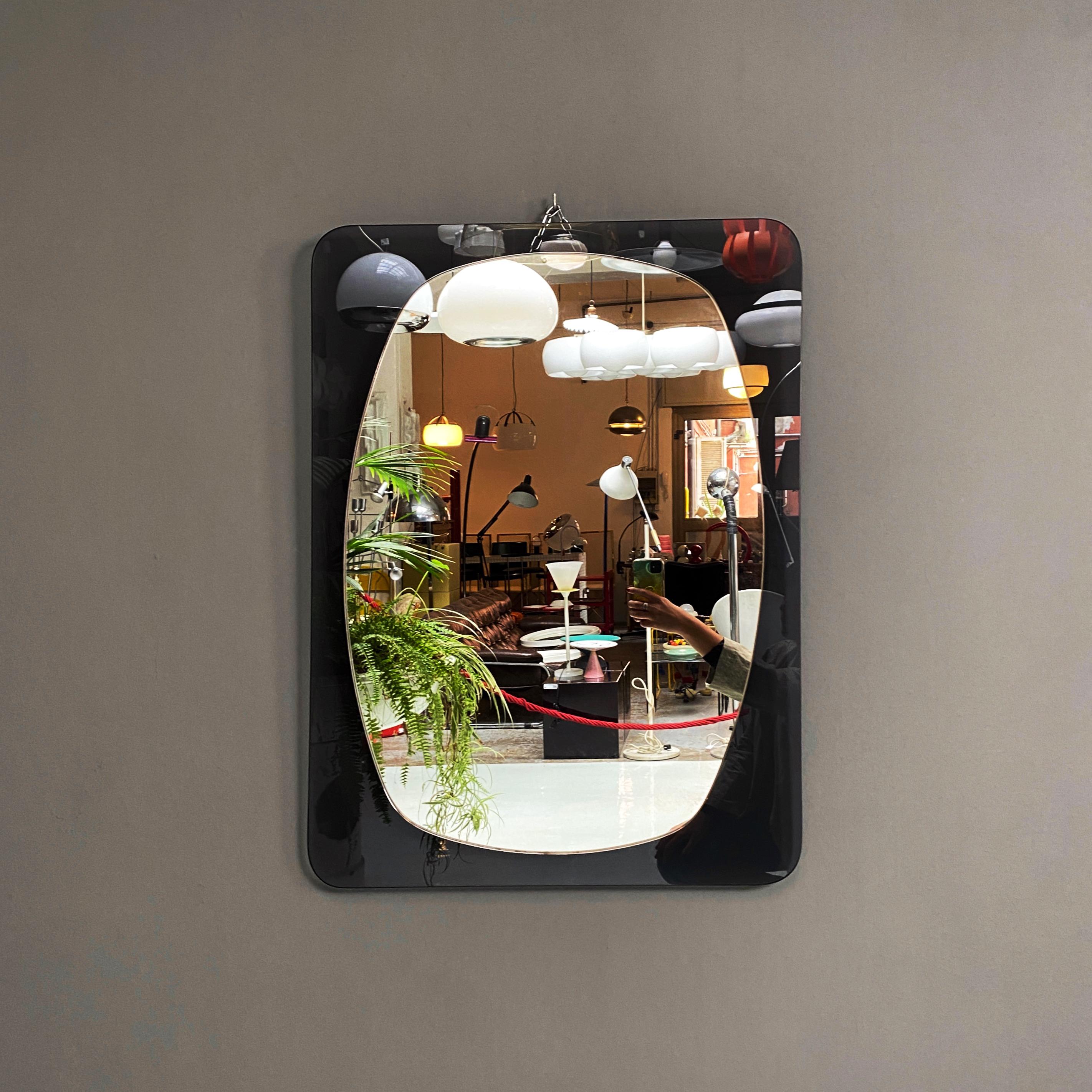 Gray glass mirror, 1970s
Rectangular mirror composed of two superimposed glasses, the base in dark gray and the mirror is irregular and rounded.
1970s

Good conditions.

Measurements 69x3x89h cm.