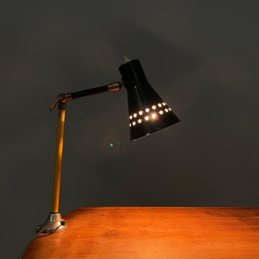 Italian mid-century modern green clamp table lamp with star holes , 1950s
Table lamp with clamp. The adjustable lampshade is in the shape of a cut cone and is made of green painted metal with two rows of star-shaped holes on the circumference. The