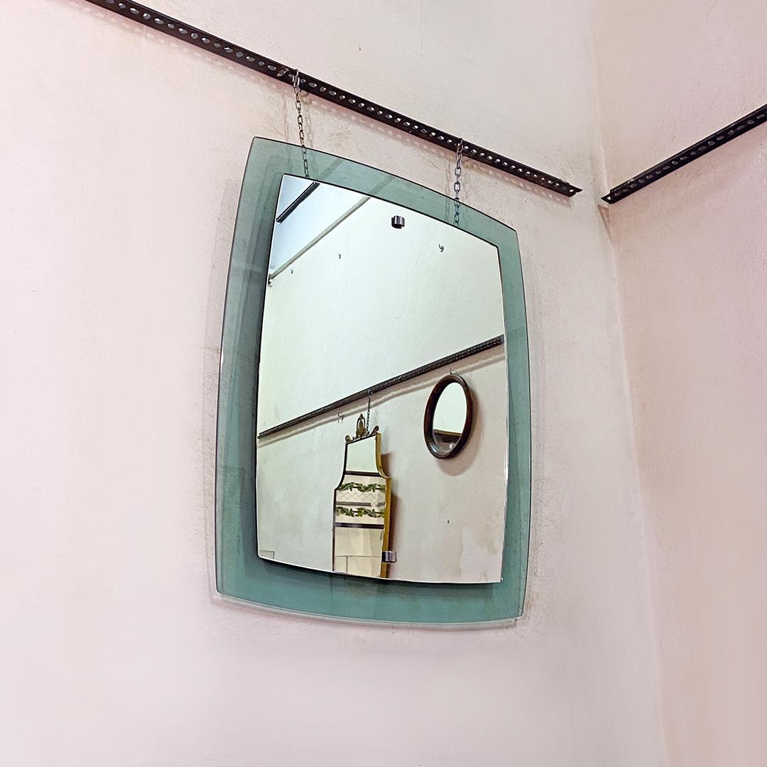 Italian Mid-Century Modern green irregular mirror with chromed details, 1970s
Green irregular mirror whit two superimposed glasses, one of which with aquamarine green glasses. 
There are two chromed steel details.

Good
