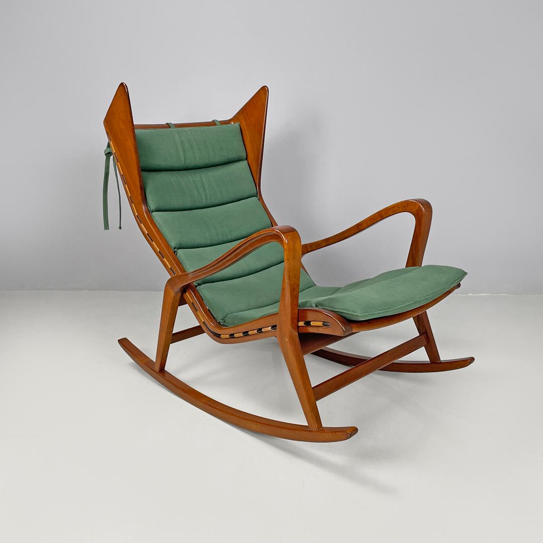 Italian mid-century modern green rocking chair 572 Studio Tecnico Cassina, 1950s
Rocking chair mod. 572 in wood with armrests. The structure follows slender and curved lines, on the sides of the upper part there are two triangular headrests, the