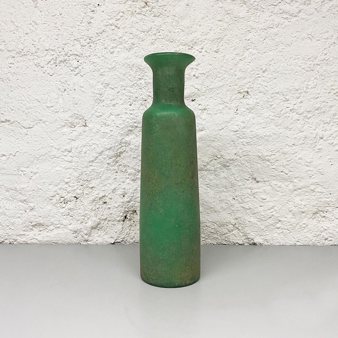 Italian Mid-Century Modern green scavo glass vase with matte finish, 1960s

This is a fantastic vase of the series named Scavo.
In particular it is green glass vase with matte finish and it appear as a vase refunded from an old era under the