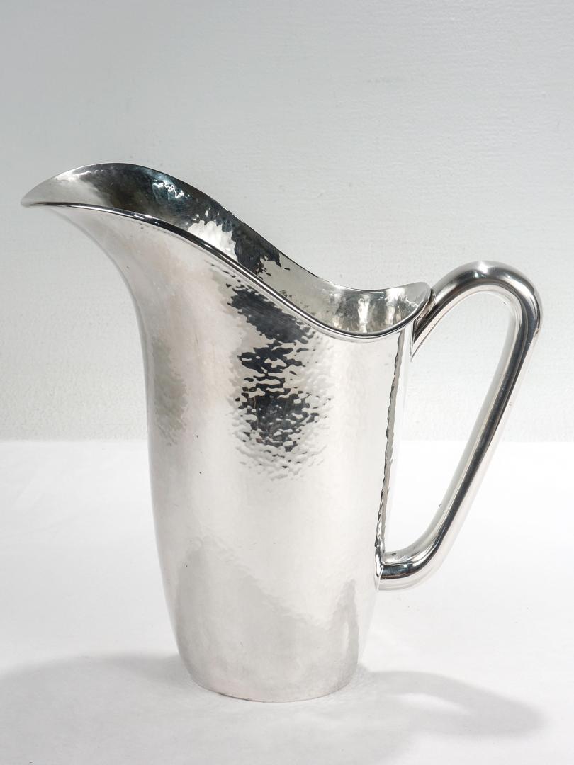 A fine Italian water or cocktail pitcher.

Marked for Fornari Roma.

In the style of Gio Ponti or Georg Jensen.

With a wide mouth, hand hammered body, and a smooth full sized handle.

Simply a wonderful Modernist pitcher!

Date:
Mid-20th