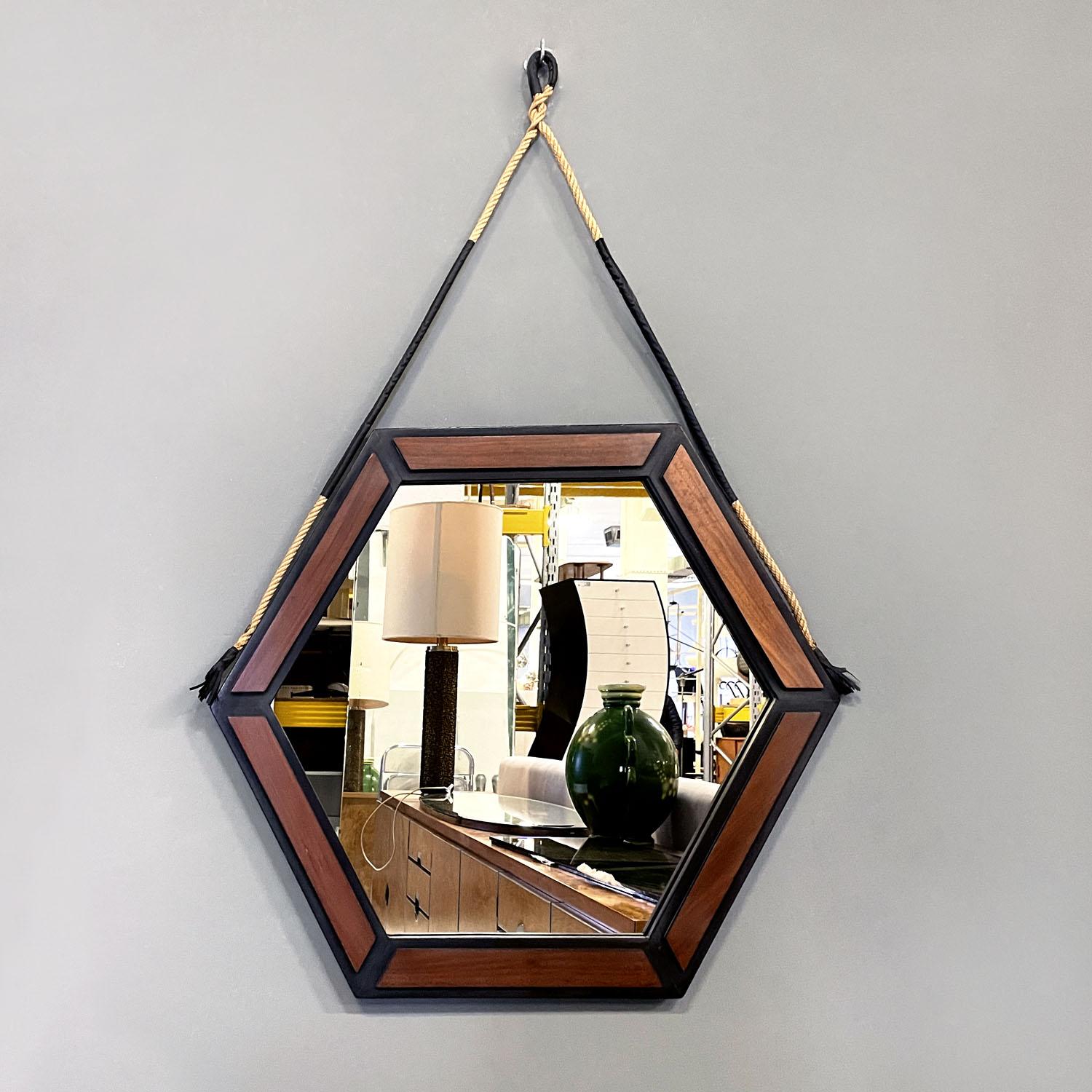Italian mid-century modern hexagonal wooden wall mirror with rope, 1960s
Hexagonal wooden wall mirror. The frame is licked black with a matte finish, on each side of the hexagon there are six smaller wooden hexagons applied on top, to create a