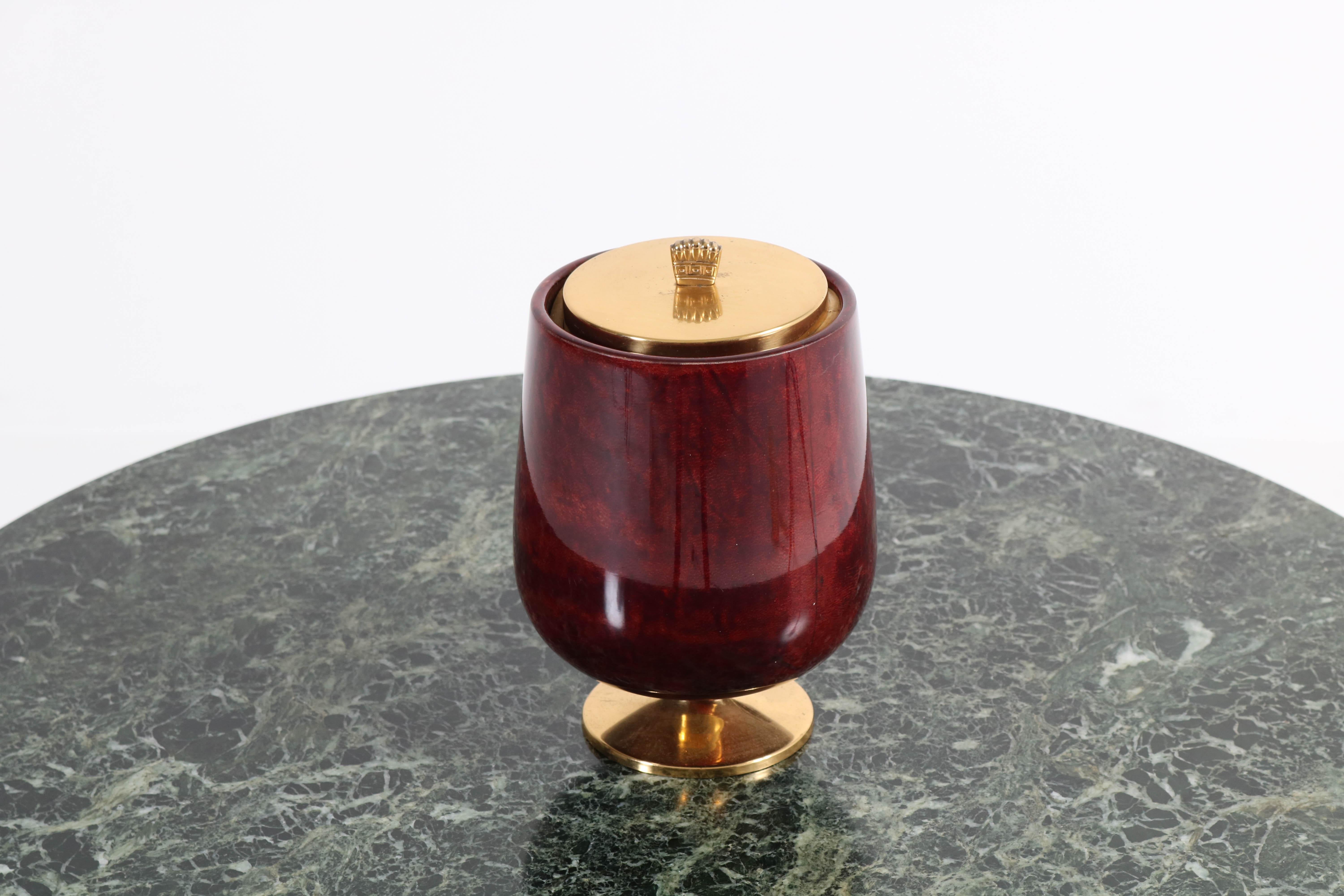 Stunning Mid-Century Modern ice bucket.
Design by Aldo Tura.
Striking Italian design from the 1950s.
Burgundy red lacquered goatskin and brass.
In good original condition with minor wear consistent with age and use,
preserving a beautiful
