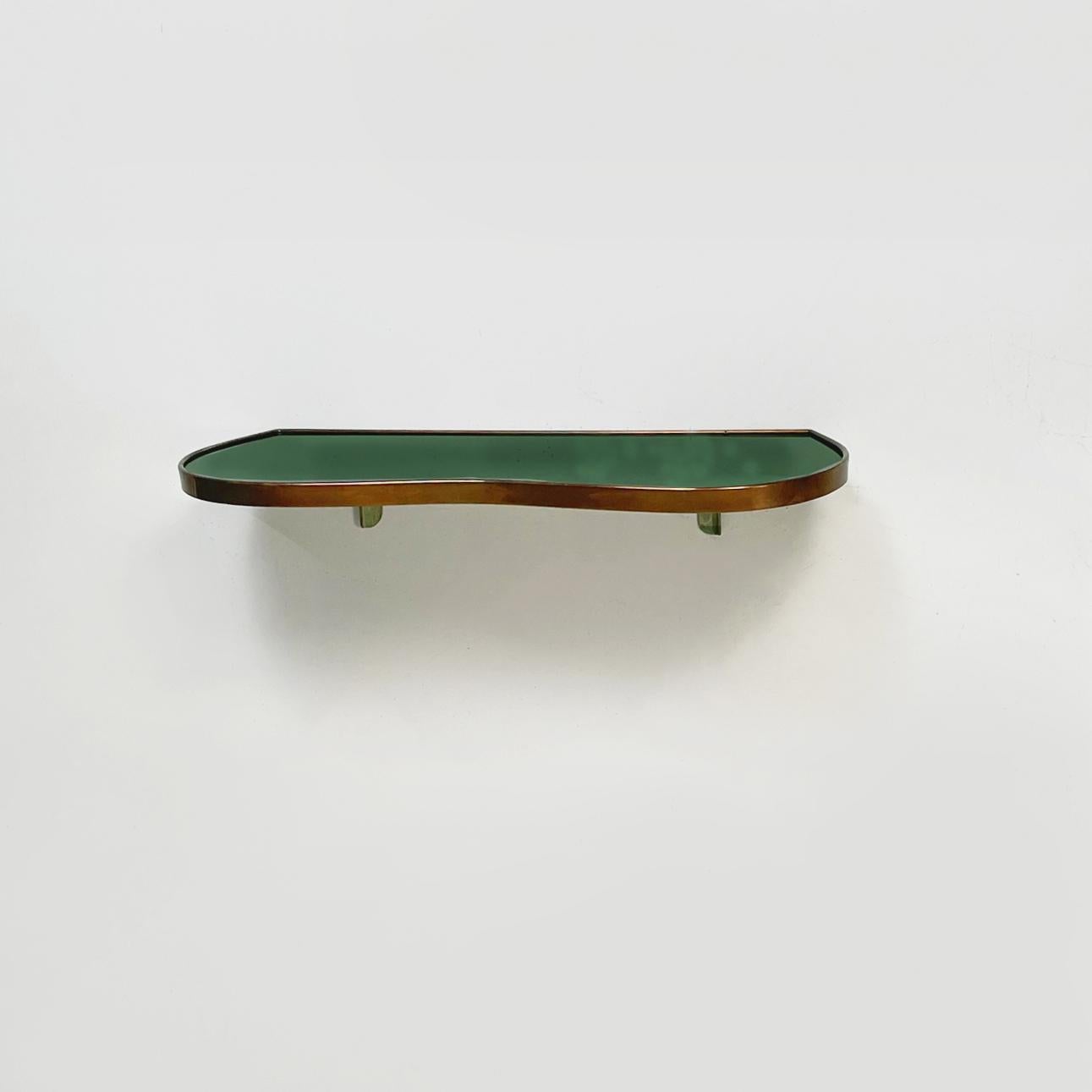 Italian Mid-Century Modern irregular shelf in green glass and brass, 1950s
Irregular rounded shelf in forest green painted glass. The profile of the shelf and the brackets are in brass.
1950s
Very good conditions, brass with patina. The original